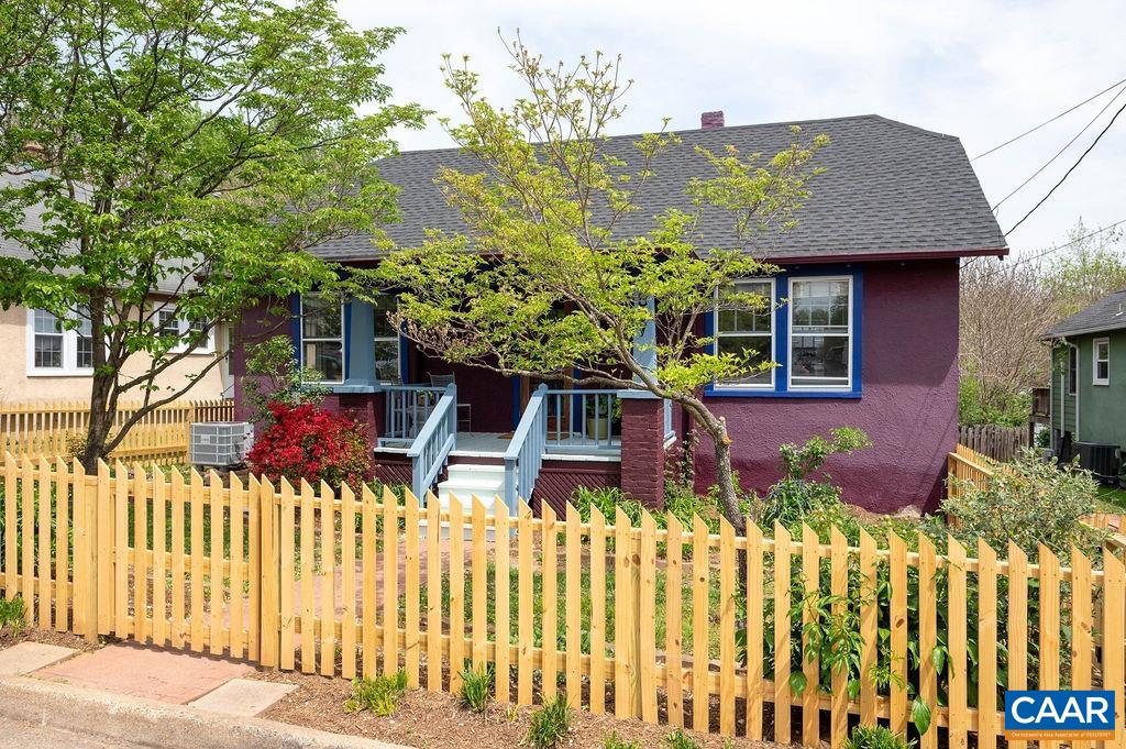 Charming Cape Cod just steps from Belmont Park and a short 10-minute walk to popular restaurants in downtown Belmont with very easy access to 64 or the UVA hospital. This sweet home features 2 bedrooms and a full bath on the main level, beautiful hardwood floors, a spacious living room and dining room, and a bright rear addition with a large family room and custom cherry built-ins. Upstairs, you'll find a private primary suite with a full bath. A separate entrance leads to a 1-bedroom efficiency apartment in the basement—ideal for guests, rental income, or a home office. Enjoy the large deck and fully fenced yard with space for a garden, plus off-street parking and a classic picket fence. Full of warmth, character, and versatile living options in a prime location!