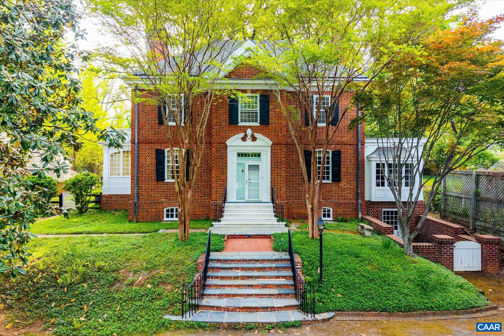 Available for the first time since 1987, this 1935 Georgian Revival estate, designed by esteemed architect Milton Grigg, offers a rare opportunity in Charlottesville’s coveted Lewis Mountain neighborhood. Crafted of hand-laid brick in Flemish bond beneath a slate roof and approached by marble steps sourced from Monticello, the residence embodies timeless architectural pedigree. Facing east toward the University of Virginia’s Academical Village, the property features 4 bedrooms, 4.5 baths, soaring ceilings, intricate moldings, and a sweeping curved staircase. A detached guest cottage, circular drive, and private gardens with brick walkways and a raised water feature complete the expansive double lot. Poised for thoughtful restoration and potential expansion, this historic property awaits its next steward to honor and enhance its extraordinary legacy. A short stroll from the Rotunda and the Lawn, and an easy drive from all of Charlottesville.