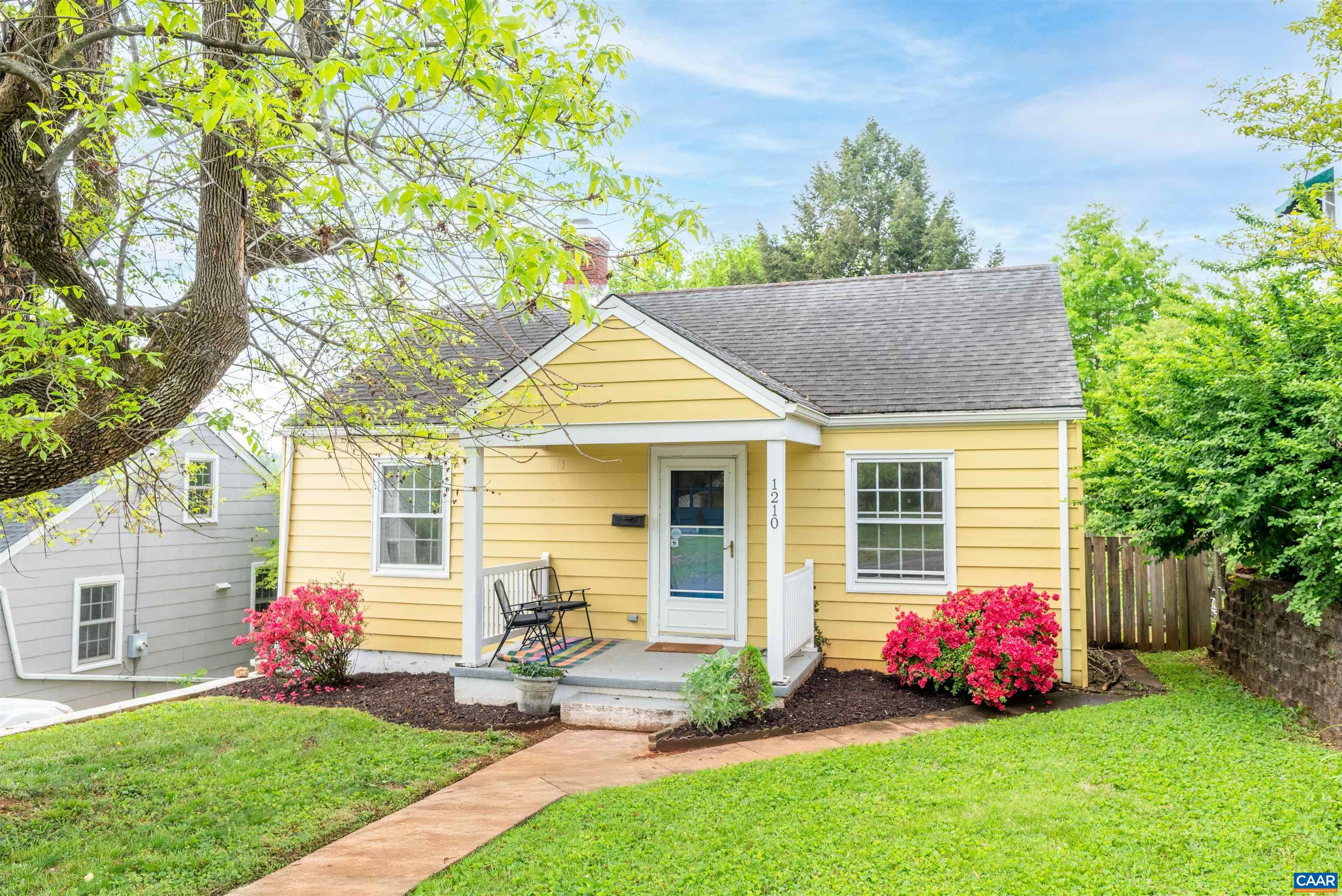 Charming 2-bed, 1-bath cottage in the sought-after Martha Jefferson neighborhood, just a short walk to downtown! This delightful home boasts a huge, fenced-in private backyard—a rare gem in the city—and an oversized one-car detached garage with power, ideal for a workshop, gym, or additional storage. Relax on the inviting front porch with picturesque mountain views, and step inside to discover the charm of arched doorways and beautiful hardwood floors flowing throughout the home. The large driveway offers ample off-street parking, and the updated kitchen appliances add modern convenience. The walk-out basement provides extra storage or space for a workout/gym and includes a washer/dryer. The fully fenced yard, complete with mature trees, offers a private oasis—ideal for pet owners and an excellent space for hosting family and friends. Ideally located, you can easily walk to downtown for restaurants, shops, and farmers' markets. Quick access to 250/64, Martha Jefferson, UVA, Sentara Hospitals, and major routes. Plus, the Rivanna Trail and River are just a stroll away!