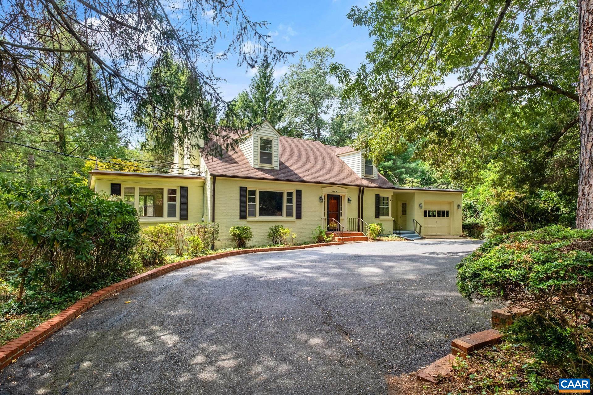 Incredible Greenbrier location with privacy on nearly an acre, surrounded by the best amenities of Charlottesville. Tucked away on a quiet cul de sac lovingly maintained and updated. Major renovations, local Alberene Soapstone counters in the new kitchen & first floor bathrooms, original hardwood floors refinished. First floor primary suite expanded w/more closet space, a door leading outside to a private outdoor living space with covered screen porch, new wood burning fireplace, ipe floors, TV, & stairs leading to a hot tub pad--addition is very reminiscent of a treehouse! Plenty of space to spread out w/5 bedrooms, 3 1/2 baths, 3 wood burning fireplaces, a deck off the kitchen, picture windows overlooking beautiful mature trees and landscaping. Lower level boasts a bedroom, full bathroom, kitchenette, family room w/fireplace, walk out access to a soapstone patio & huge backyard with original hardscaping. Invisible fence for dogs. Walk in 10-15 minutes to: Rivanna Trail, Brooks YMCA, Whole Foods, CHS, Walker MS, Greenbrier Park, McIntire skate park, Triangle MTB flow trails. 5 minutes in the car gets you to Downtown Mall, Barracks Rd shops, I-64, 29N shops, Greenbrier Elementary. This much space in the city is rare, call today!