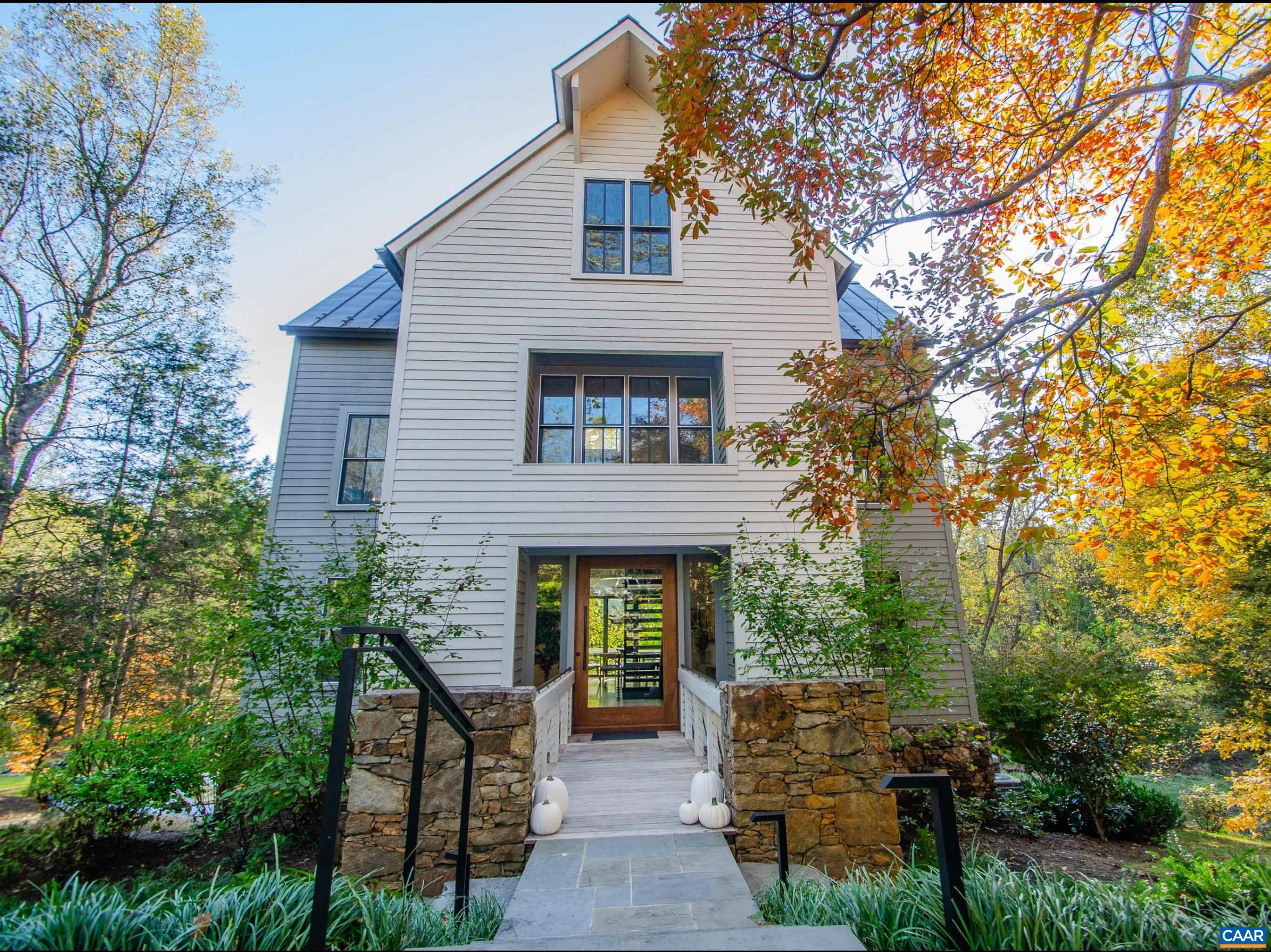 A breathtaking architectural masterpiece in Inglecress, offering nearly 5 acres of luxury, privacy, & natural beauty. Perfectly sited at the end of a peaceful cul-de-sac. Spectacular 4,432SF custom home showcases 4 bedrooms, 3 full and 2 half baths, & a dramatic modern design, fully reimagined by Alexander-Nicholson w/ the finest craftsmanship & materials. Step through a stunning mahogany pivot door into sun-drenched living spaces with soaring ceilings, sleek steel-and-oak staircases, and walls of glass framing endless pastoral and wooded views. The designer chef’s kitchen dazzles w/ Thermador appliances, marble waterfall counters, & custom cabinetry, flowing seamlessly into expansive living & dining areas w/ multiple fireplaces and a NanaWall opening to the elevated deck. Luxury primary suite is a true sanctuary w/ French doors overlooking Ivy Creek & a spa-worthy bathroom. The top floor offers a vaulted guest retreat, while the ground level features a chic family room, wet bar, and 2-car garage. Private elevator, whole-house generator. Relax on elevated deck, gather around the fire pit near the creek, or roam your own park-like grounds w/ direct trail access and 825ft of waterfront.