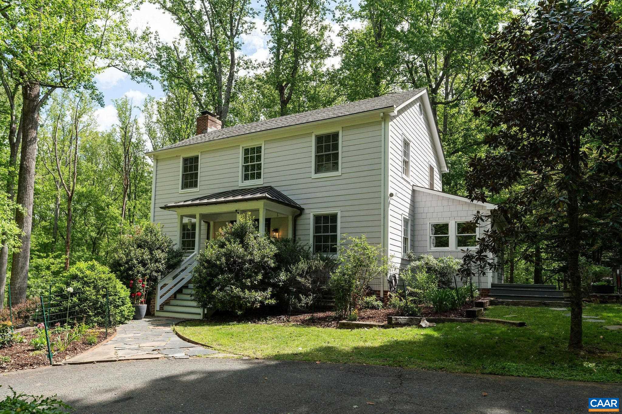 Charming home on an incredible lot on one of Ivy's most coveted streets. Enter the property and be enchanted with mature trees, green lawns, and surprising privacy.  Curb appeal galore with hardiplank siding, copper roofing and half round gutters on the front porch, and classic architectural lines. Main floor features a formal dining room and living room with wood burning fireplace which flows to the kitchen and lightfilled sun room currently used as an office. Second entrance off the driveway conveniently leads to the kitchen via mudroom offering wonderful amenities including storage benches, laundry, and powder room. Gas Wolf range, dishwasher, butcher block island, and dedicated pantry cabinets are highlights of the eat in kitchen. Heading upstairs you'll find the generous owner's suite with large tub, slate tile shower, and streaming natural light. Two more bedrooms and full bathroom in the hall complete the second floor. Walkout basement includes den with wood stove and ample storage space. Room to run and play or even add on in the future if you need more space. Get into the neighborhood at an approachable pricepoint and make it your own. Shown by appointment. OPEN HOUSE 5/10 2-4