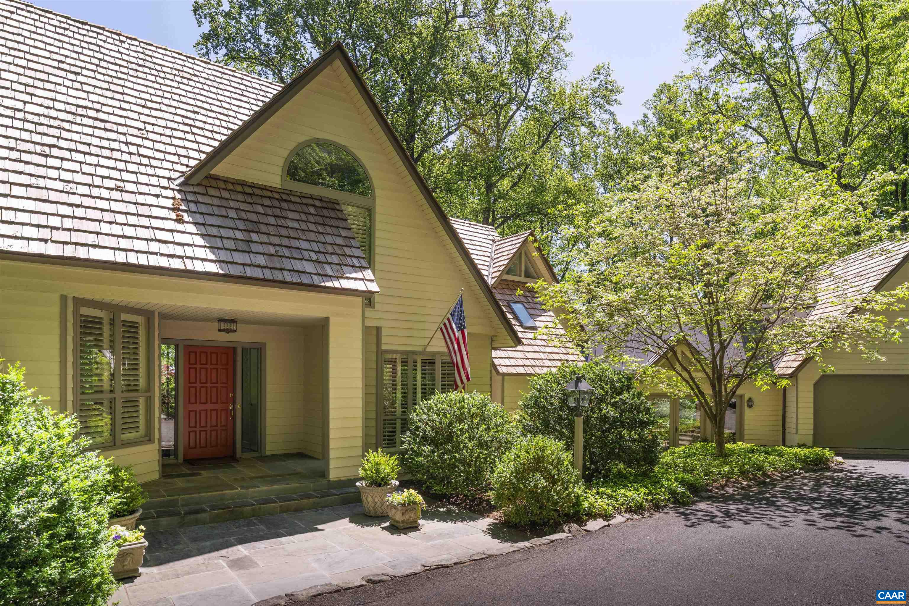Beautiful and architecturally distinct home tucked away on 2.56 private acres in highly desirable Ednam Forest. Surrounded by mature trees and set back from the road, this property offers privacy, space, and quiet—all just minutes from Boar’s Head Resort, the Sports Club, UVA and downtown Charlottesville. Inside, the home offers 4,500 square feet across three levels, with flexible living spaces perfect for gathering or retreat. The sun-filled living room opens to a vaulted four-season sunroom overlooking the pool terrace—an ideal spot for morning coffee or evening entertainment. The kitchen has been thoughtfully updated with bright cabinetry, ample prep space, and a large island for casual dining. Additional highlights include a private pool, sauna, home office, and 4 large bedrooms, offering plenty of room for family and guests. Classic details and warm finishes run throughout. Whether you're seeking a peaceful retreat or a home built for entertaining, this Ednam Forest property offers timeless charm in one of Albemarle’s most coveted neighborhoods. Shown by appointment only.