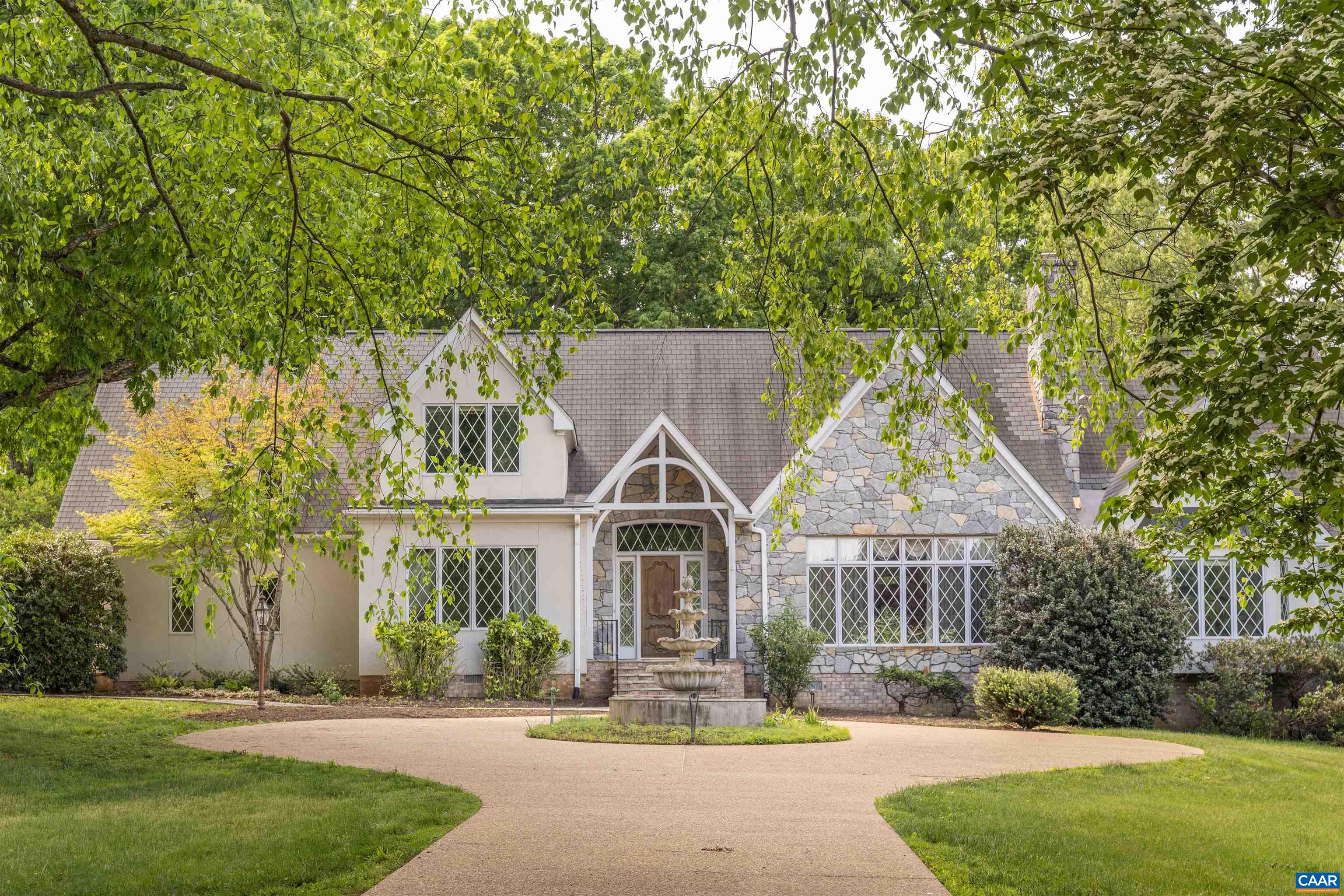 Situated on nearly 7.5 manicured acres amongst the scenic & rolling terrain of Western Albemarle ,on the highly coveted Garth Road,  is this stunning, completely custom English Country-style residence  only 5 miles from town! Designed & constructed with premium finishes & unparalleled attention to detail, the stone & stucco home features an extremely functional and inviting, light-filled floor plan, cathedral ceilings, elegant moldings, striking stone fireplace, with custom built-ins throughout. There is a large primary bedroom suite on the main level along with an adjoining second bedroom suite.  Upper level has a 3rd bedroom, full bath, office or study, and huge loft area to covert a 4th bedroom, and  family room. Other features include three bay garage,  and generous well-appointed kitchen w/ adjoining breakfast room, leading to covered exterior porch. The surrounding grounds offer a  truly lovely setting, with gorgeous landscaping, towering oak trees , large goldfish pond and magnificent views of the surrounding pastoral countryside. PRICED TO SELL, LISTED ALMOST $200,000 BELOW CURRENT ALBEMARLE CO. TAX ASSESSMENT!!!