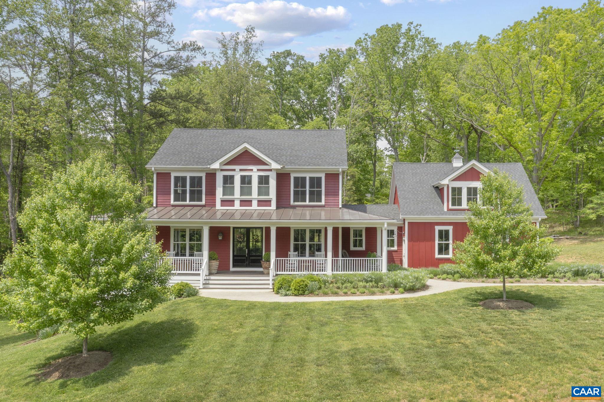 On 2.2 acres in a coveted neighborhood in Ivy, this 2016 home impresses at every turn with myriad wow factors from room to room. It features premium finishes, nine-foot ceilings on all three levels, and a thoughtful floor plan that blends comfort and style. The heart of the home is a striking kitchen, with a Calcutta marble island and built-in refrigerator, that opens to a great room with built-ins, large windows, and a wood-burning fireplace. Classic dining and living rooms flank the standout entry, while a playroom, mud room, and wet bar complete the main floor. Upstairs, there is a showstopping primary suite that includes a sitting area, gas fireplace, ensuite bathroom, and spacious walk-in closet. There are two additional bedrooms of good size that share a tasteful Jack and Jill bathroom. The walkout terrace level includes a handsome rec room, the fourth bedroom that doubles as a perfect guest suite, and immense storage. There is a fifth bedroom above the garage that is currently used as an office. In turnkey condition, every room of this house is a showpiece. Enjoy impressive outdoor spaces, too, including a large front porch, covered back deck, and fire pit, plus an outdoor shower and tons of room to spread out and explore.