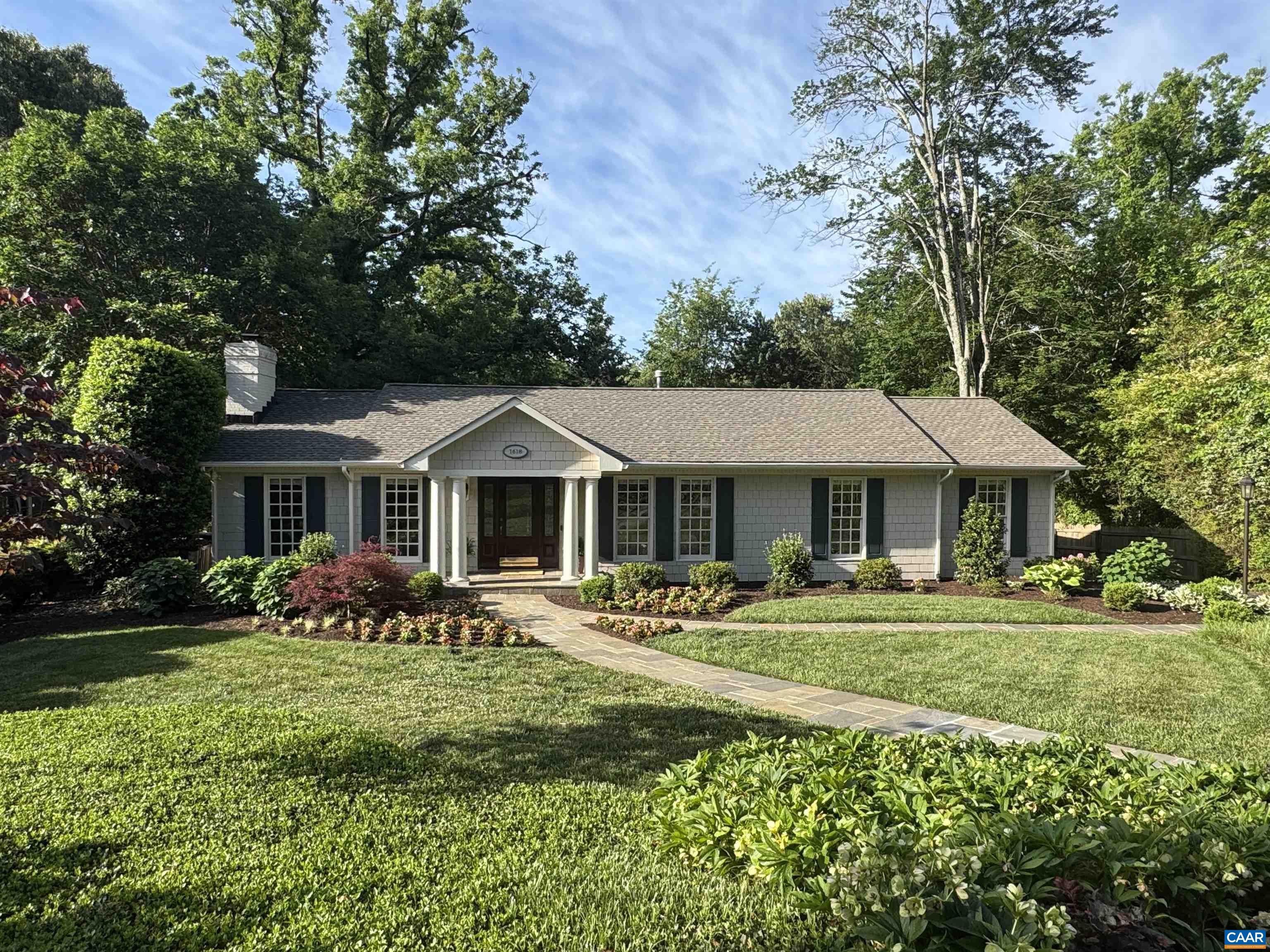 Just minutes from UVA and downtown Charlottesville, this beautifully renovated home blends timeless style with flexibility on a 0.37-acre lot. The open-concept kitchen, living, and dining areas flow to a large deck—ideal for entertaining. The main level features three spacious bedrooms, each with an en suite bath, plus a laundry room and half bath. The terrace level adds a large rec room with half bath, home office, second full kitchen, a fourth bedroom with en suite bath, and a fitness room with its own half bath—perfect for guests, multigenerational living, or a large family. Enjoy lush, mature landscaping with year-round perennials in a tranquil setting. An oversized two-car garage includes a soundproofed, fully finished studio apartment above—ideal for visitors, remote work, or creative use. Located on a wide, tree-lined street in one of Charlottesville’s most desirable neighborhoods, this rare property offers flexible living space, rental potential, and room to host.