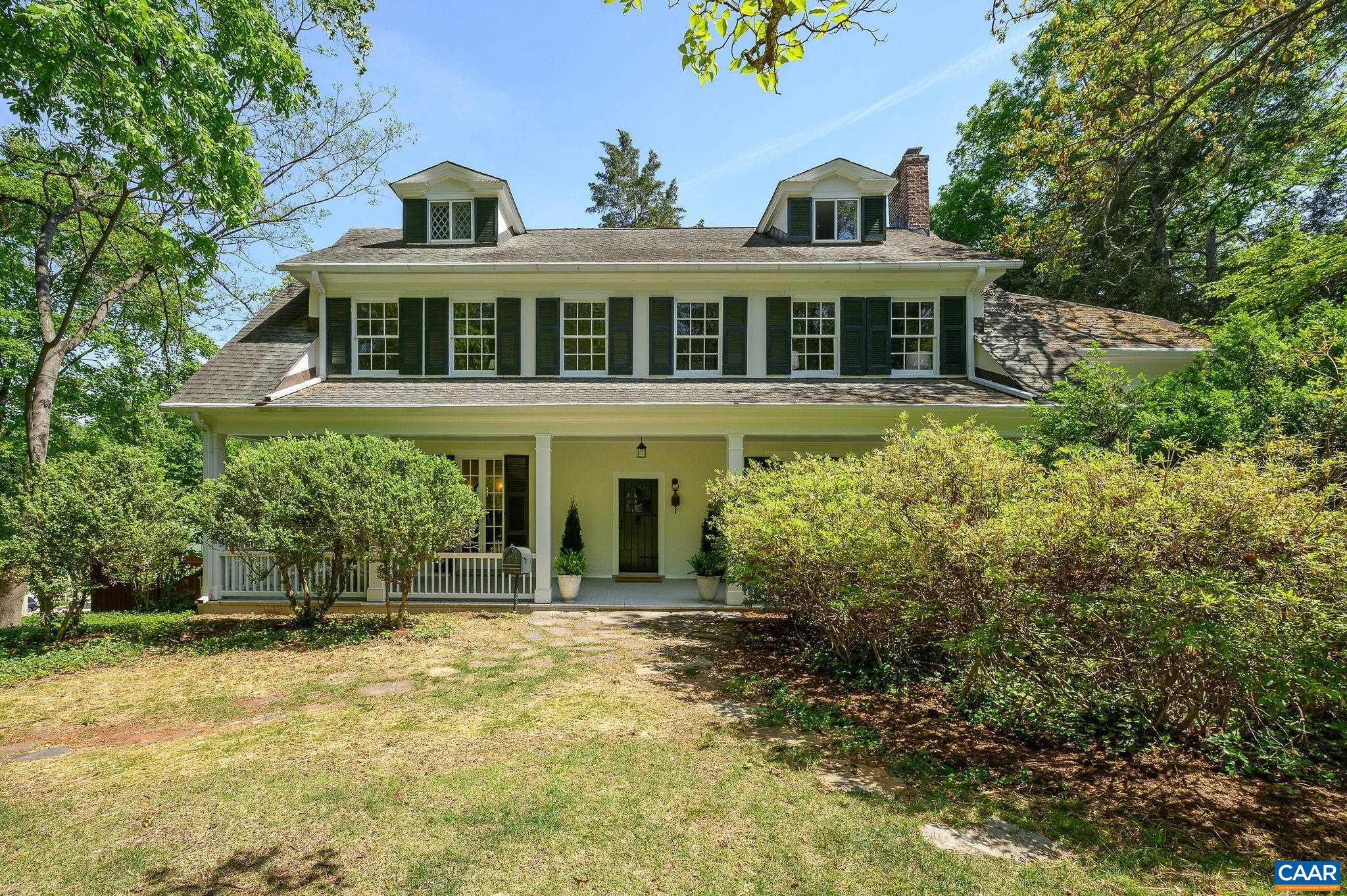 Stunning C. 1917 Rugby Road estate available for the first time in nearly 50 years. The main house features a deep full front porch, inviting foyer, living room, library, apartment/office/main level primary option, generous dining room, expanded renovated kitchen. The second level features a four-room ensuite primary suite plus additional bedrooms and bath. The third floor offers a large open room, bedroom and bath. The covered back porch steps down to the lush expansive landscaping with stone terrace, stone steps to the writers/art studio. The studio boasts a vaulted ceiling, skylight, oversized window, sleeping loft. There's also a detached garage/workshop. Just over an acre offering privacy and room to enjoy the beautiful mature park like landscape. Fresh paint inside and out.
