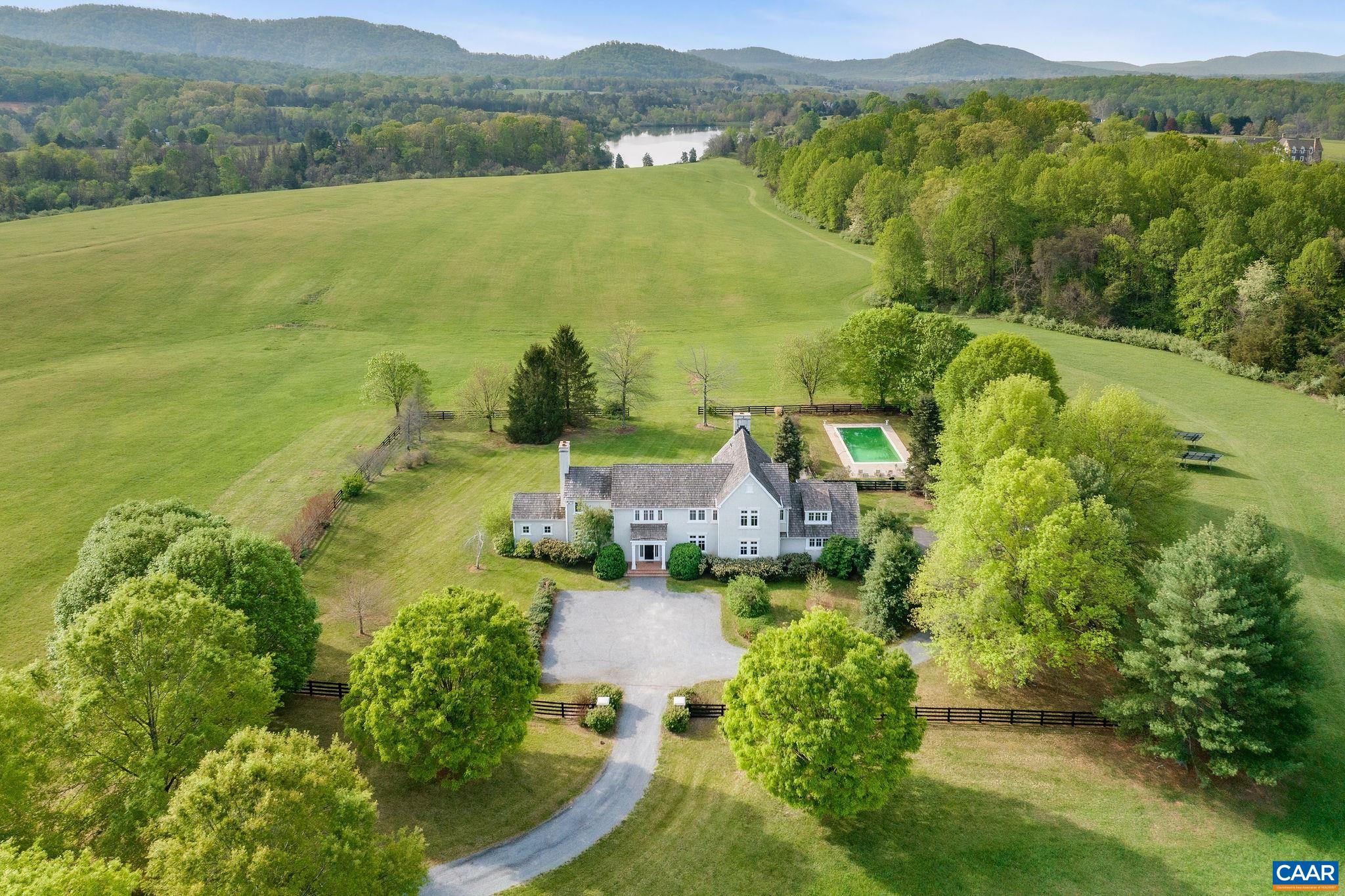 Enchanting 42 acre estate nestled amongst long rolling pastures, accented by breathtaking mountain views & a rich rural character, in truly one of the most picturesque communities in all of Central Virginia, Blandemar Farm Estates - yet only 10 miles to the City of Charlottesville & UVA. Stunning 5 bedroom, 3.5 bath stucco residence has over 4,500 finished sq.ft. of comfortable living space throughout 2 levels, and is built with top quality materials & craftsmanship. The main level is highlighted by a lovely flowing floor plan w/ spacious natural light filled rooms, artful finishes, gorgeous hardwood floors, three wood burning fireplaces, and access to a covered rear patio, perfect for relaxation, entertaining & more. The second level hosts the primary suite w/ large walk-in closet, 3 bedrooms w/ new carpet, plus a bonus room with a multitude of uses. The property is beautifully landscaped, and also features a private pool. Made up of two 21 acre parcels, which is rare in this neighborhood, and also backing up to a shared pond, it's hard to imagine a more perfect setting!