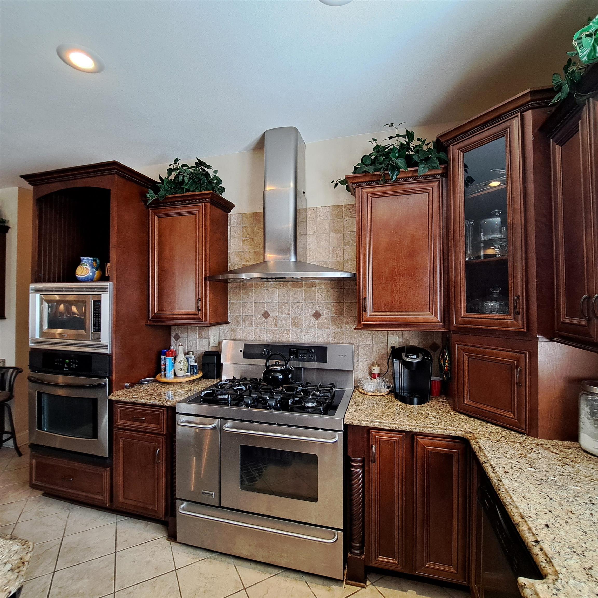 PLUS a 2nd built in eye level oven and microwave.  Truly a chef\'s kitchen.  All custom design cabinets and matching stainless steel appliances.