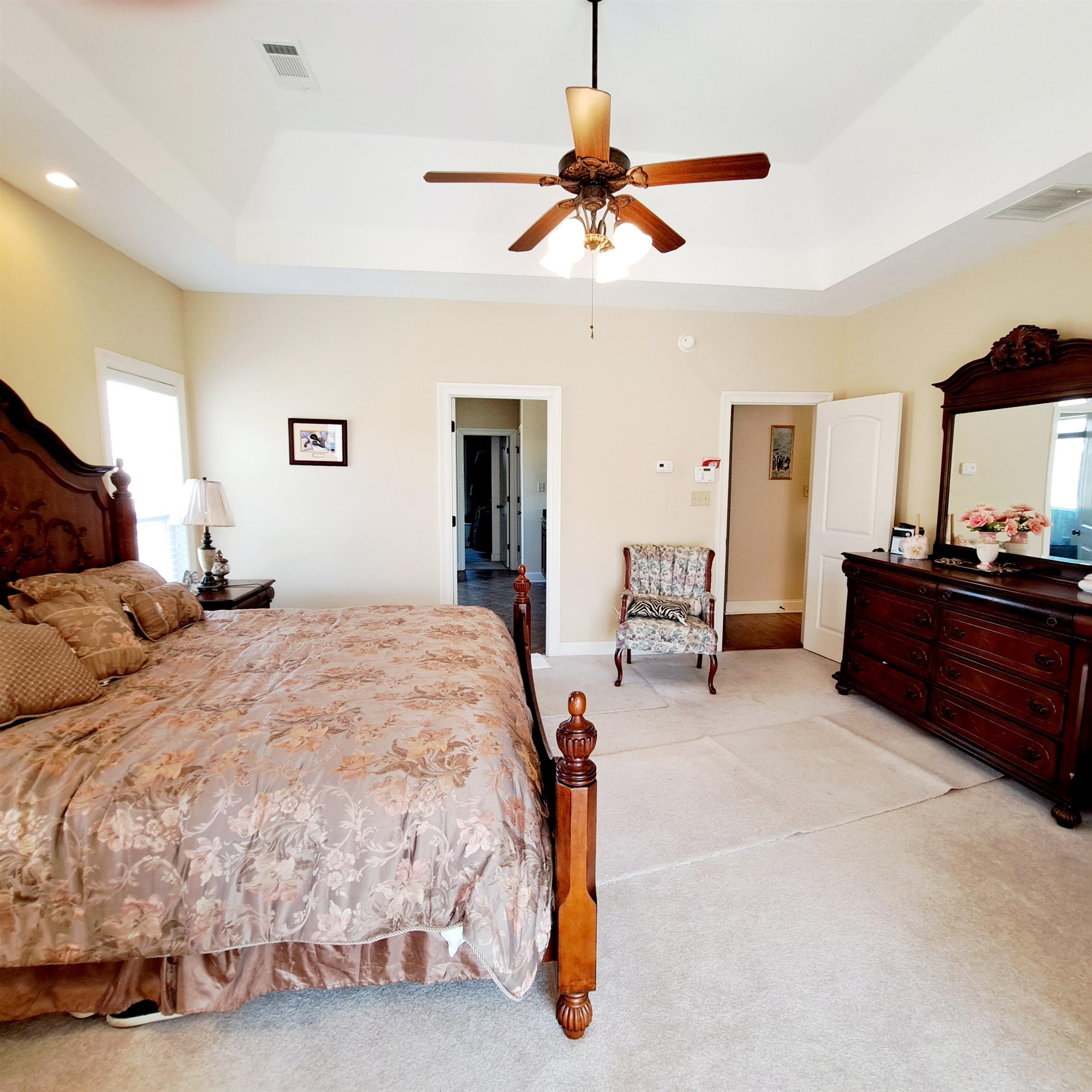 Huge primary suite with sitting area for relaxing, reading books, or enjoying the view of the private and secluded back yard. Separte entrance to covered patio as well.