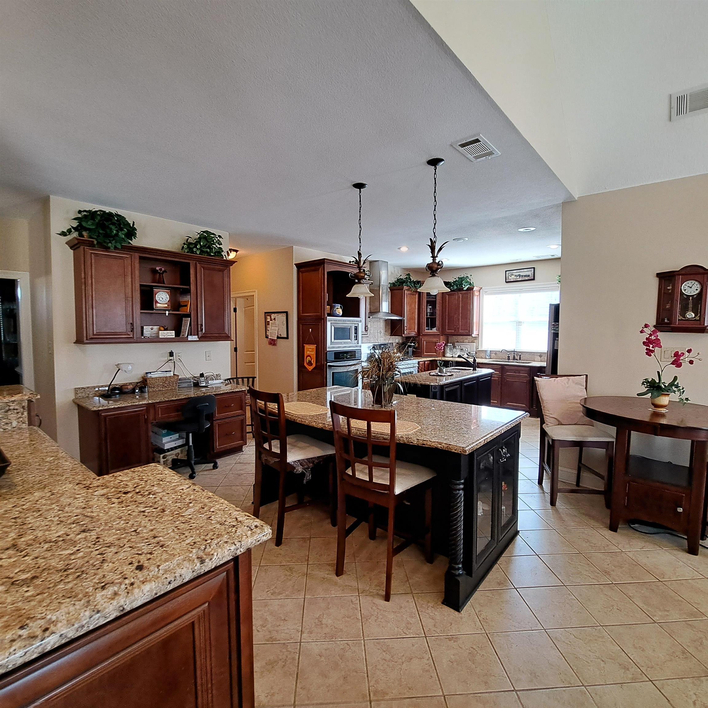 Stunning arches, colums, breakfast bar with custom cabinets, with tons of storage drawers and shelves for you whatnots.