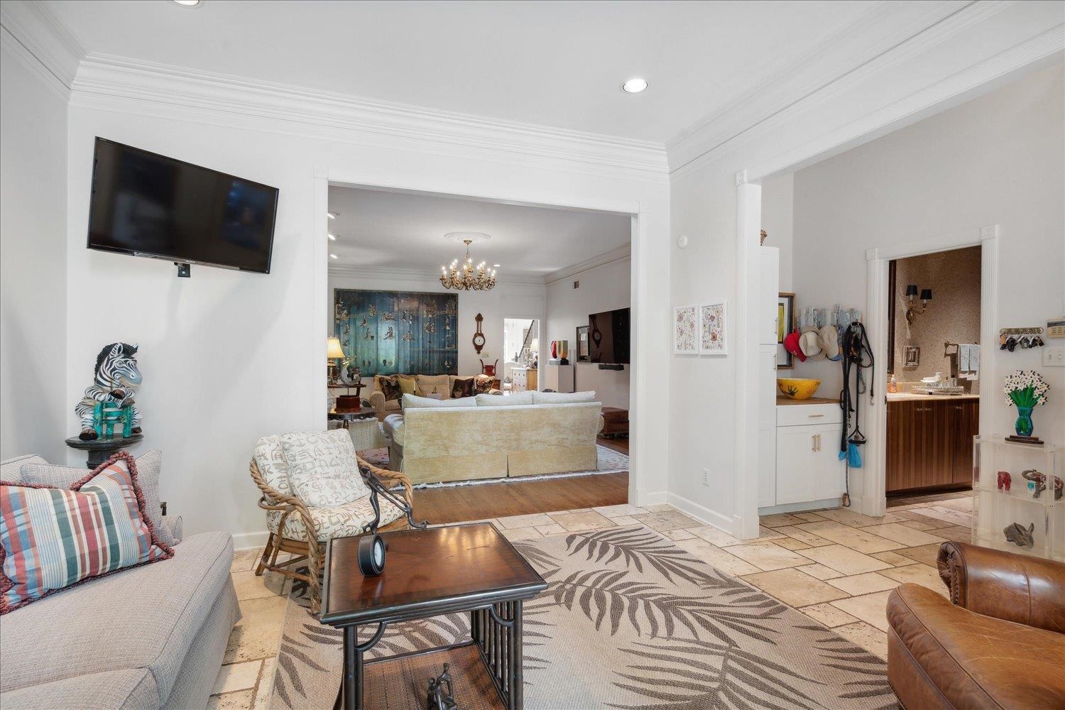 Sunroom off great room with tile floors.