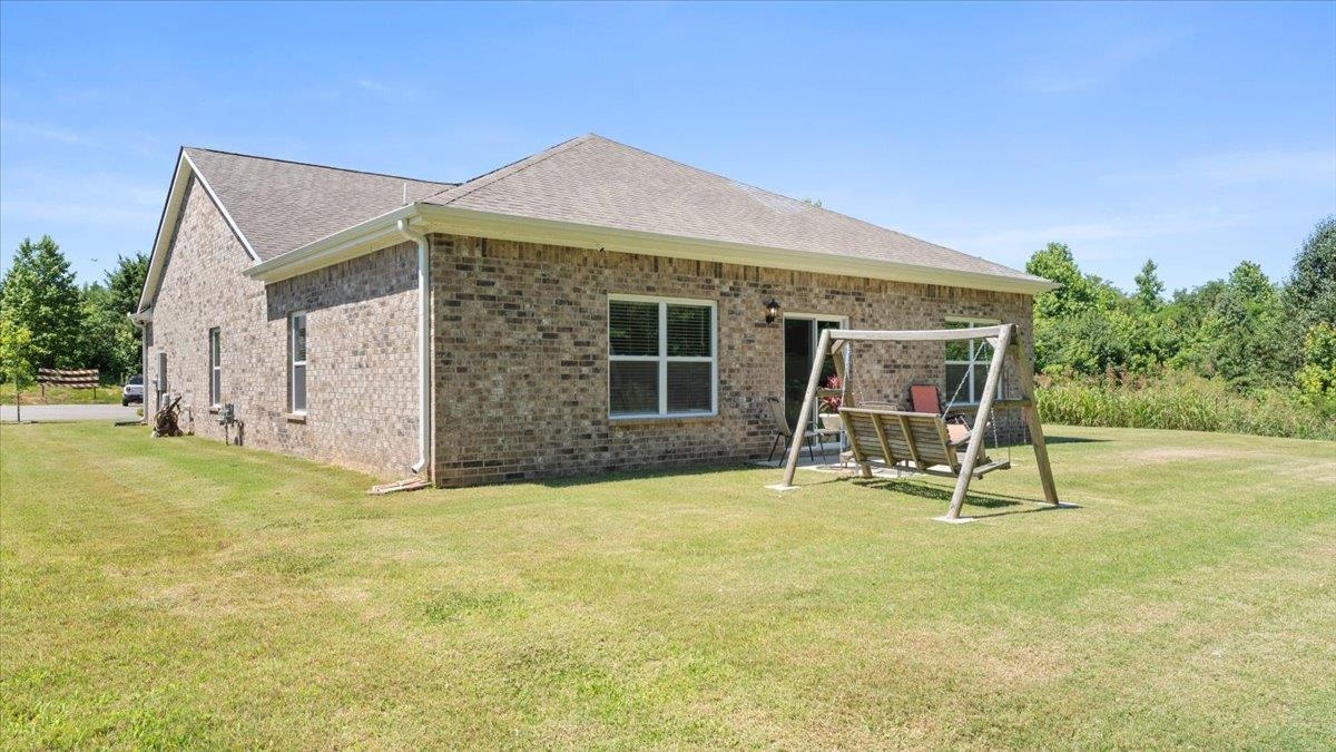 Back of house featuring a lawn