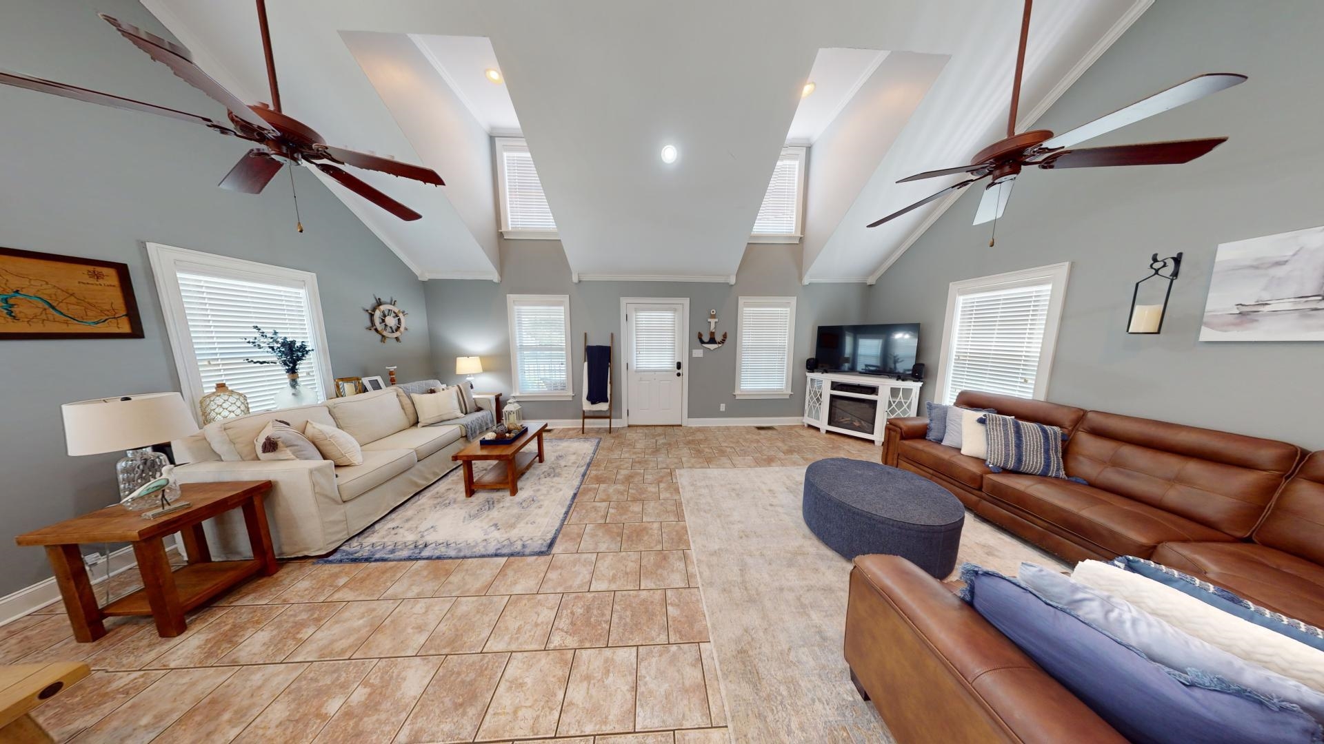 Living room with high vaulted ceiling and ceiling fan