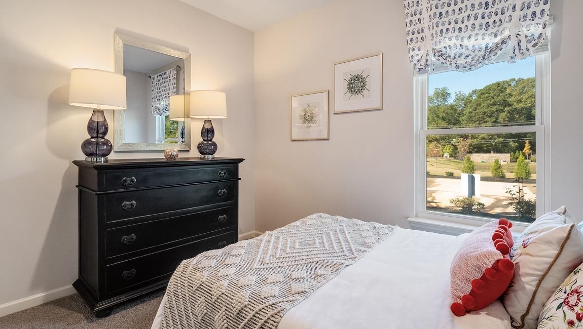 Bedroom featuring carpet flooring and multiple windows