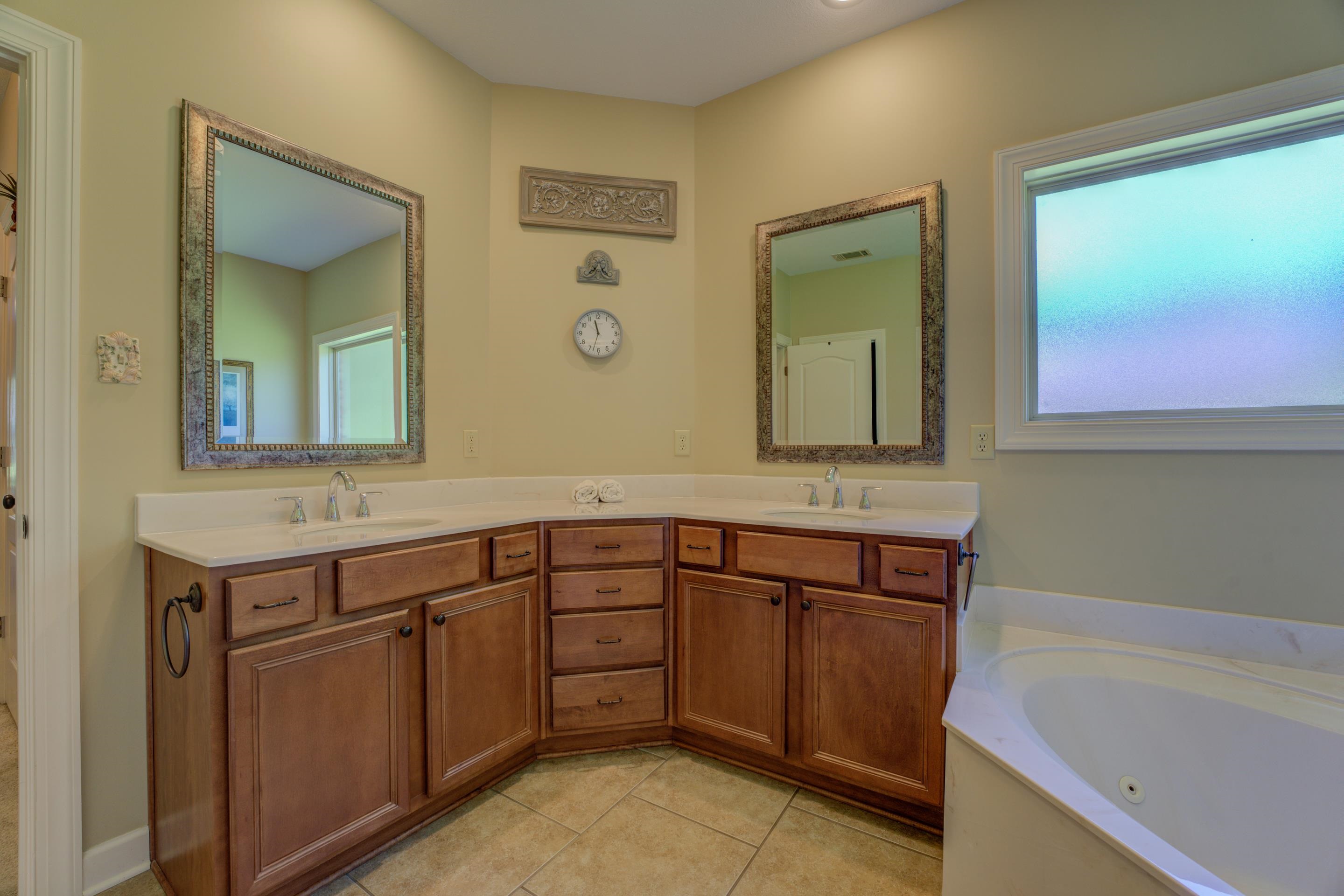 Bathroom featuring tile floors, vanity with extensive cabinet space, and dual sinks!