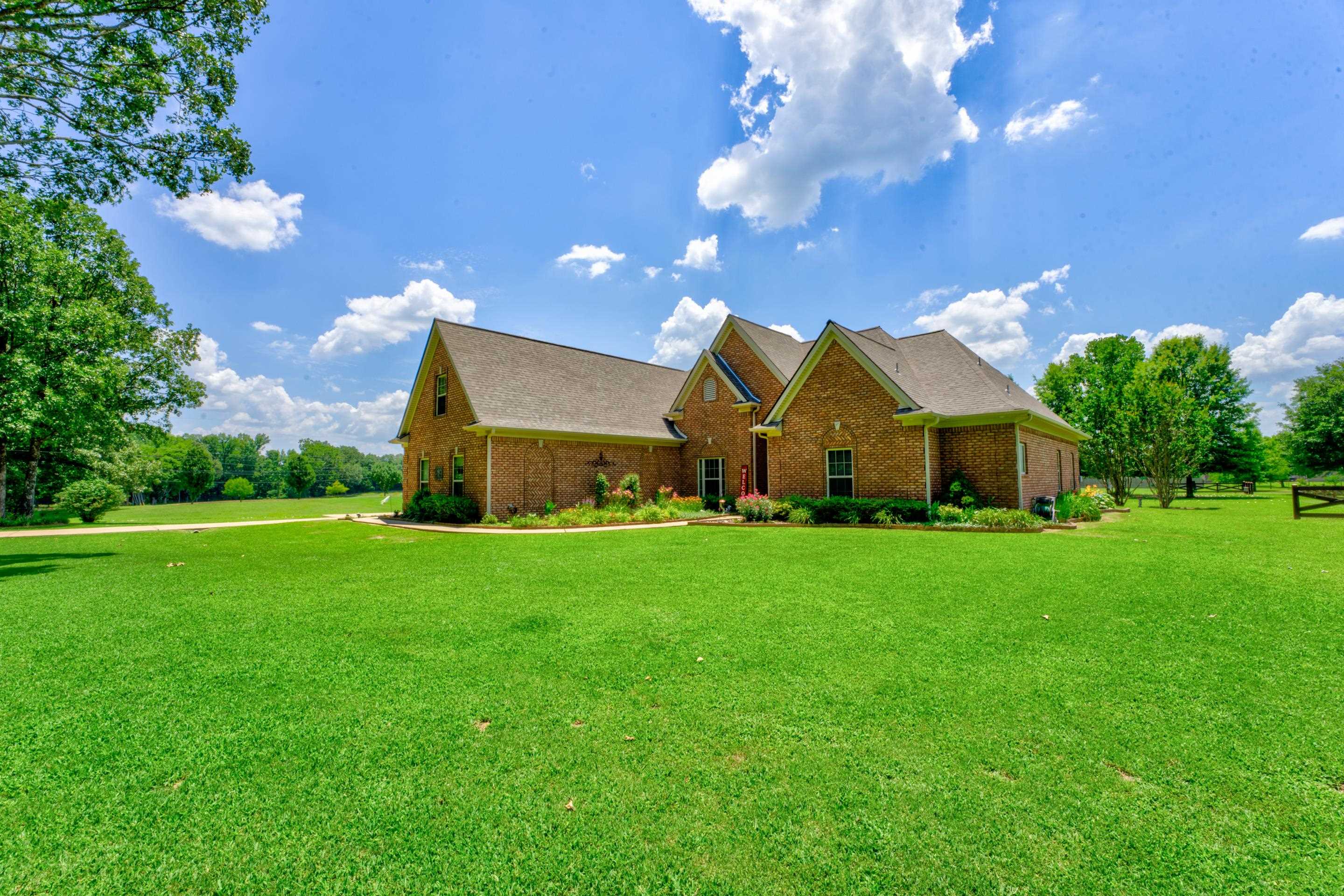 View of front of Home with a front yard with Flower Beds.
