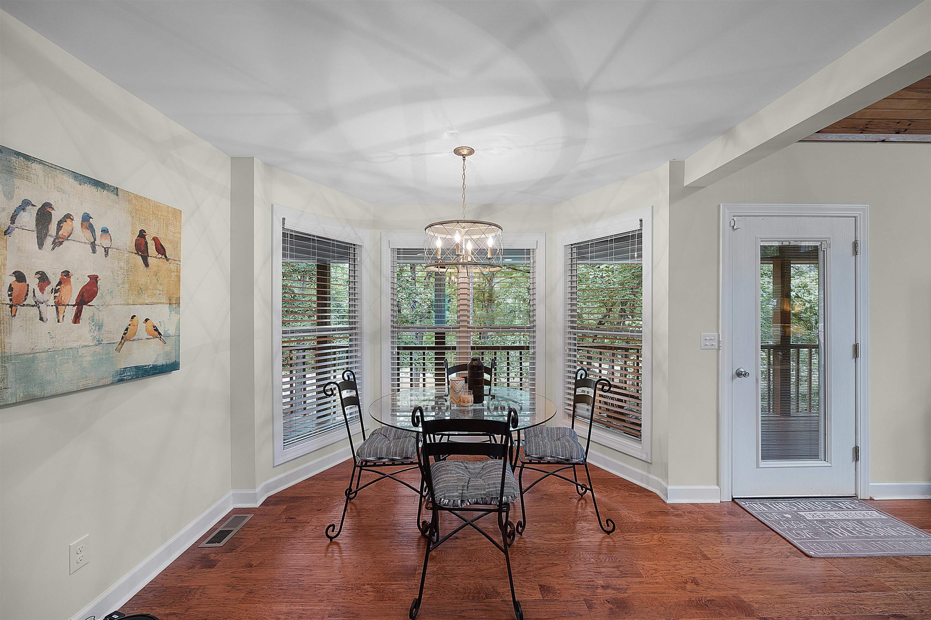 Dining area featuring a notable chandelier and hardwood / wood-style flooring