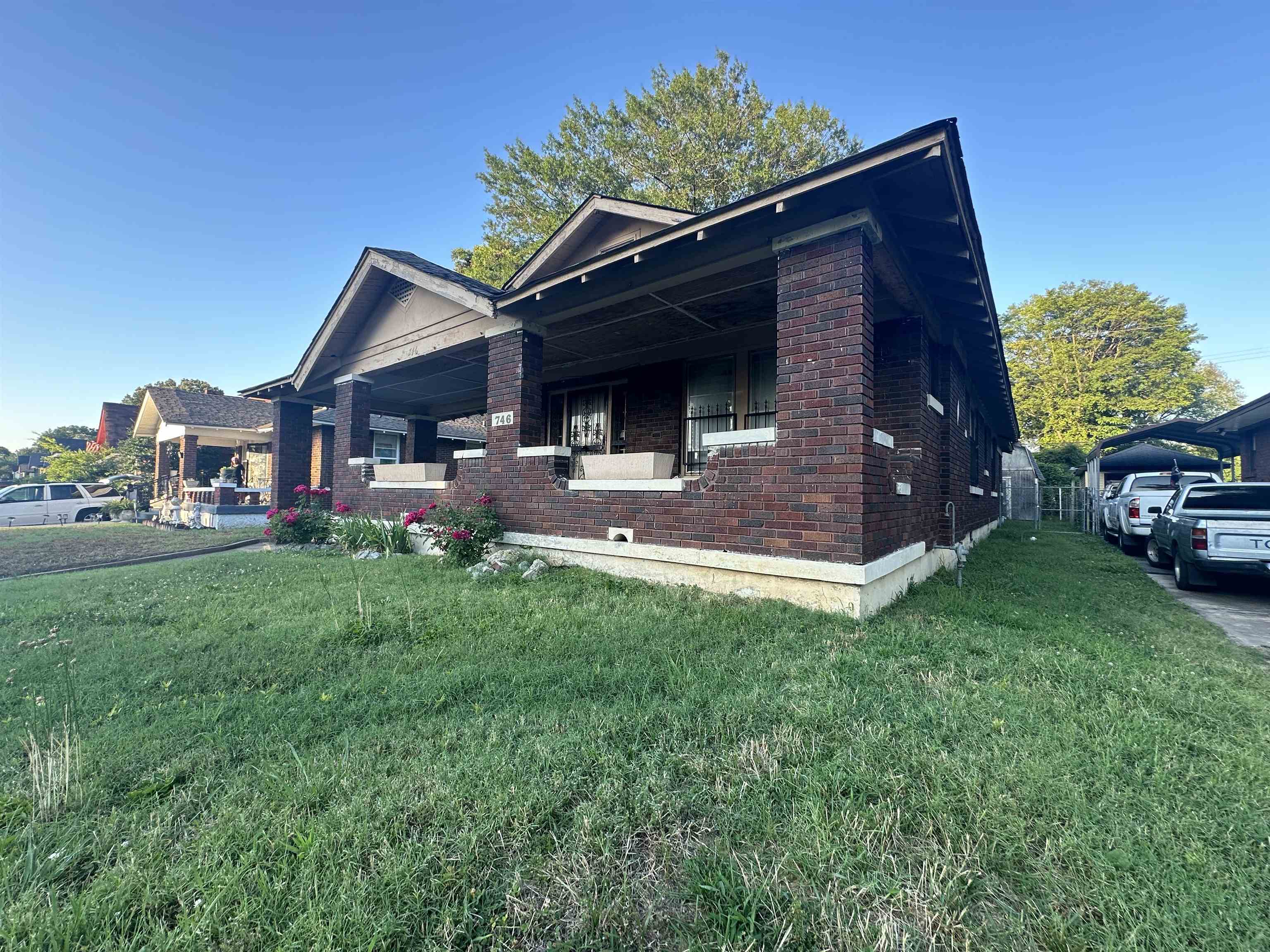 View of front of property featuring a front lawn and a porch