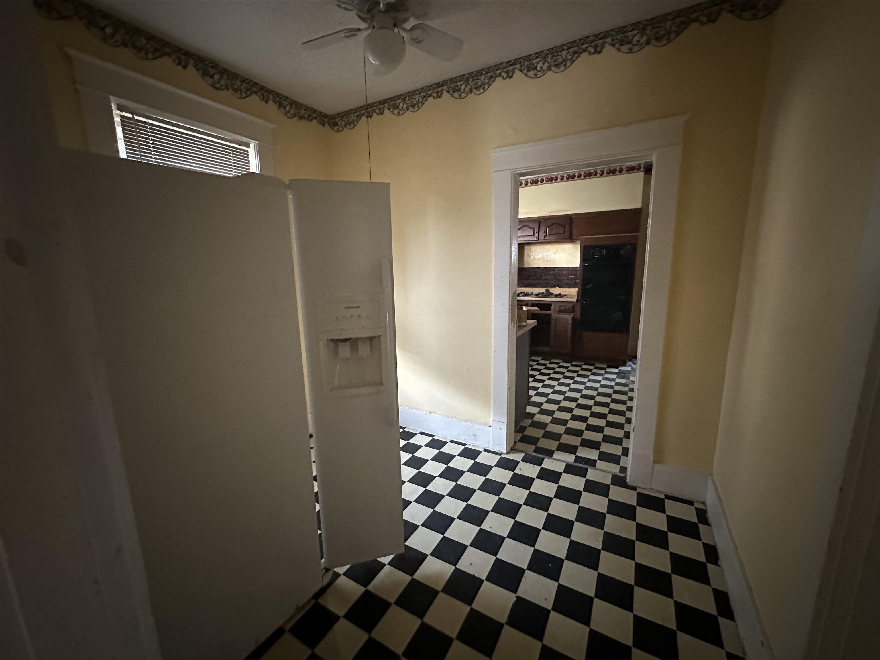 Corridor featuring dark tile floors