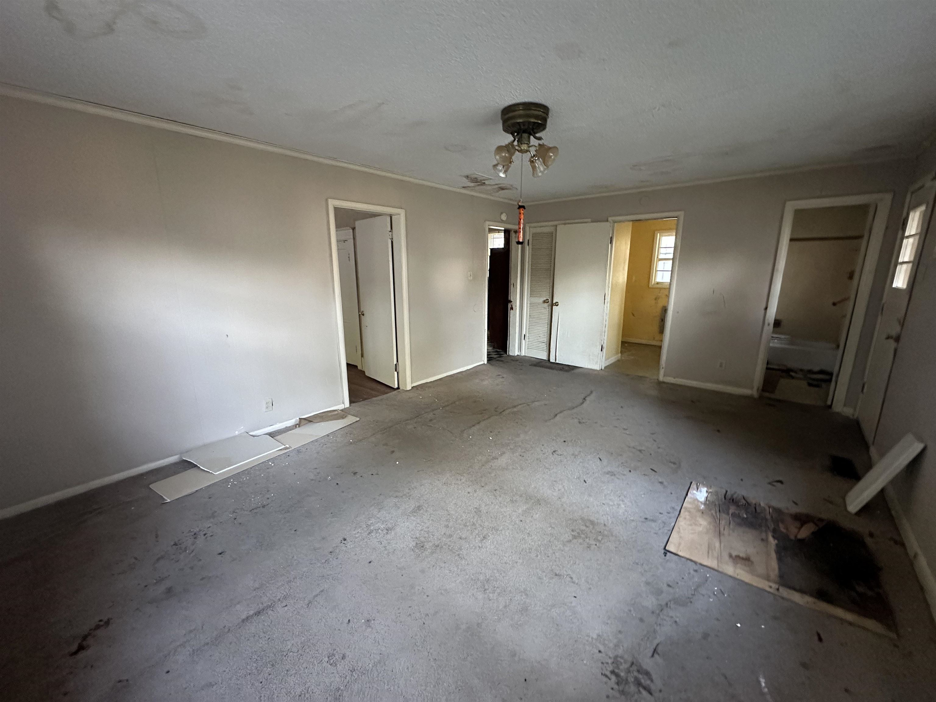 Unfurnished bedroom featuring ceiling fan and ensuite bath