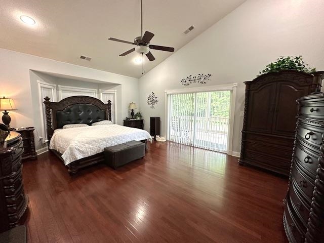 Bedroom with high vaulted ceiling, dark wood-type flooring, ceiling fan, and access to outside