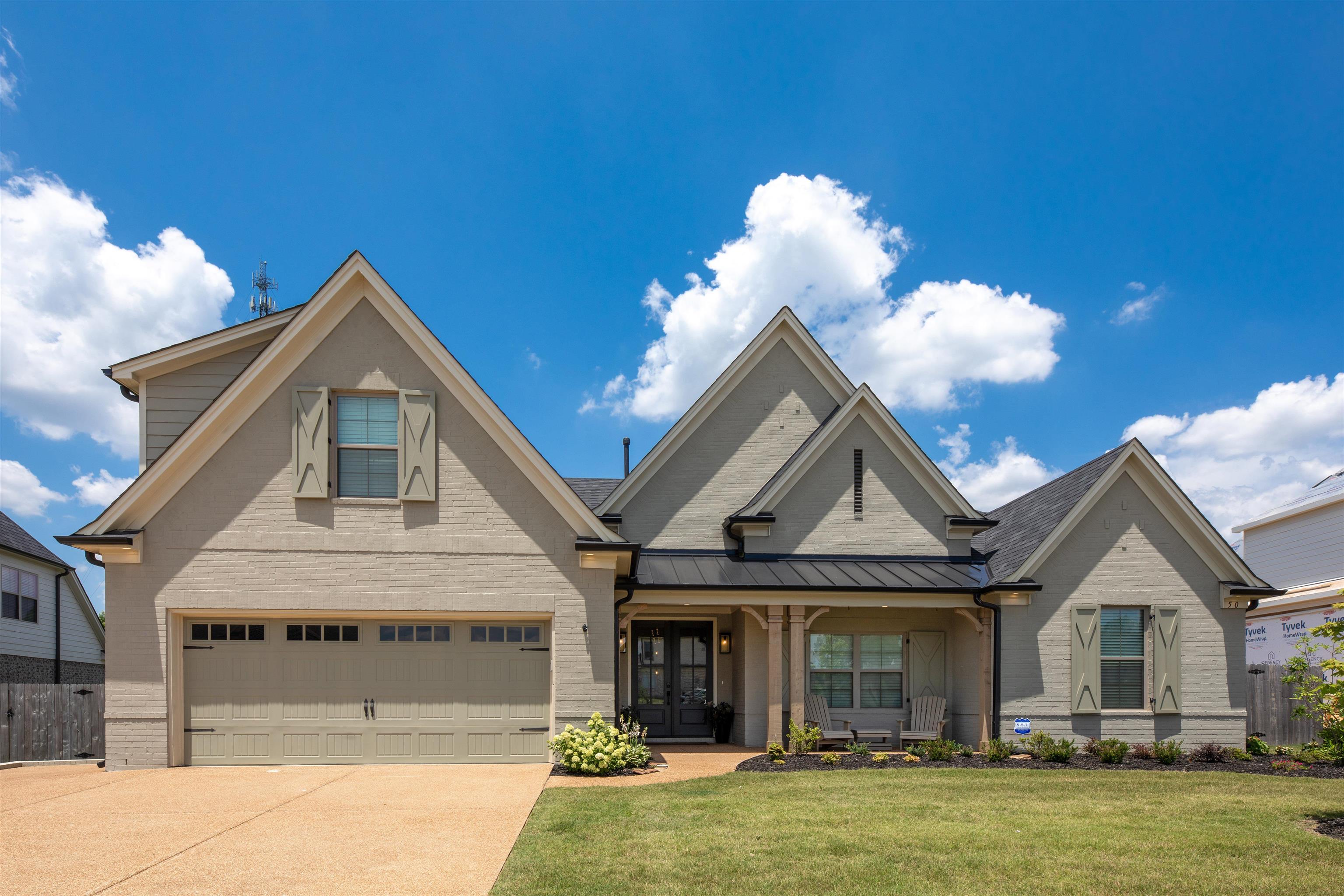 View of front of home with a garage and a front yard