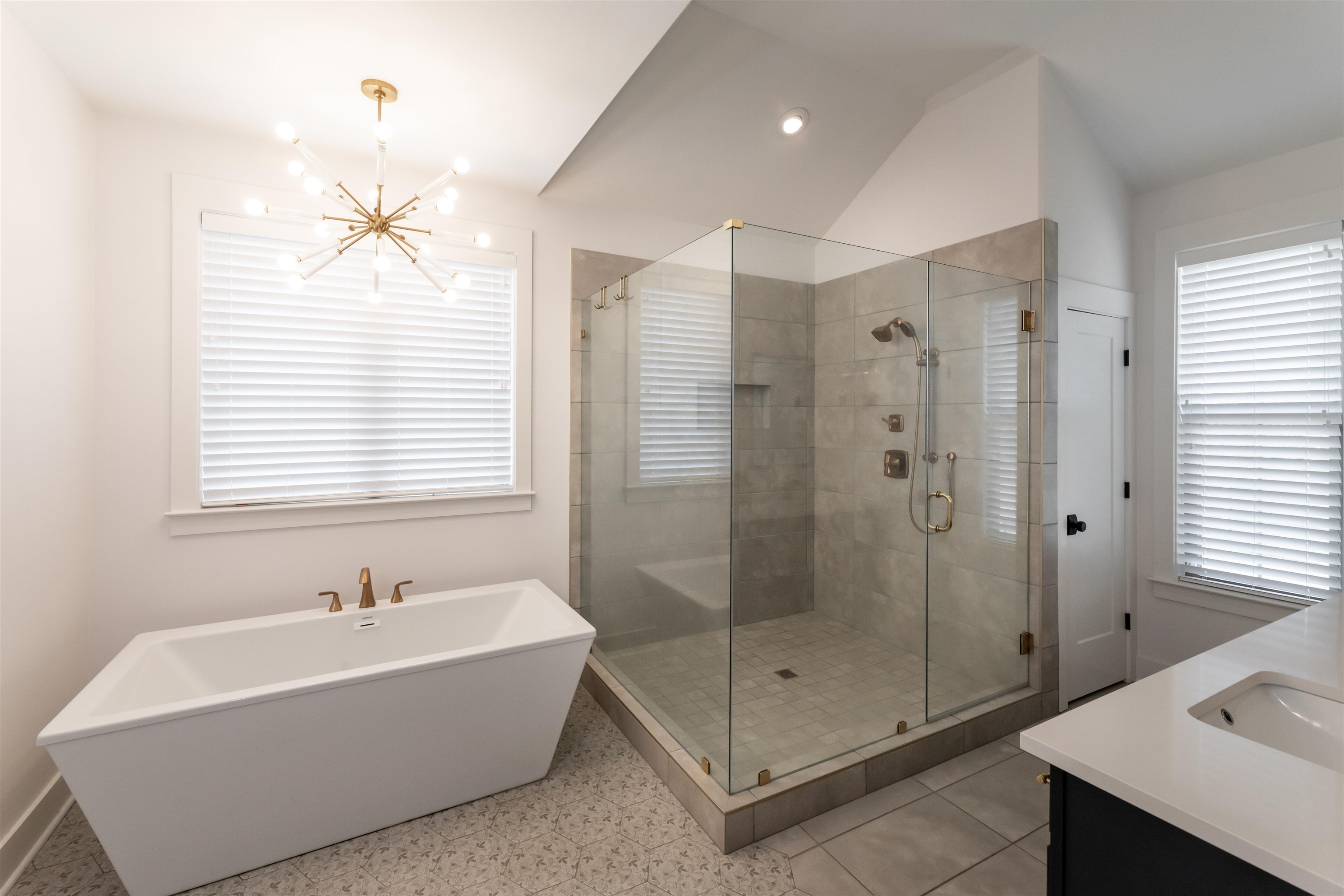 Bathroom with shower with separate bathtub, tile floors, a notable chandelier, vanity, and vaulted ceiling