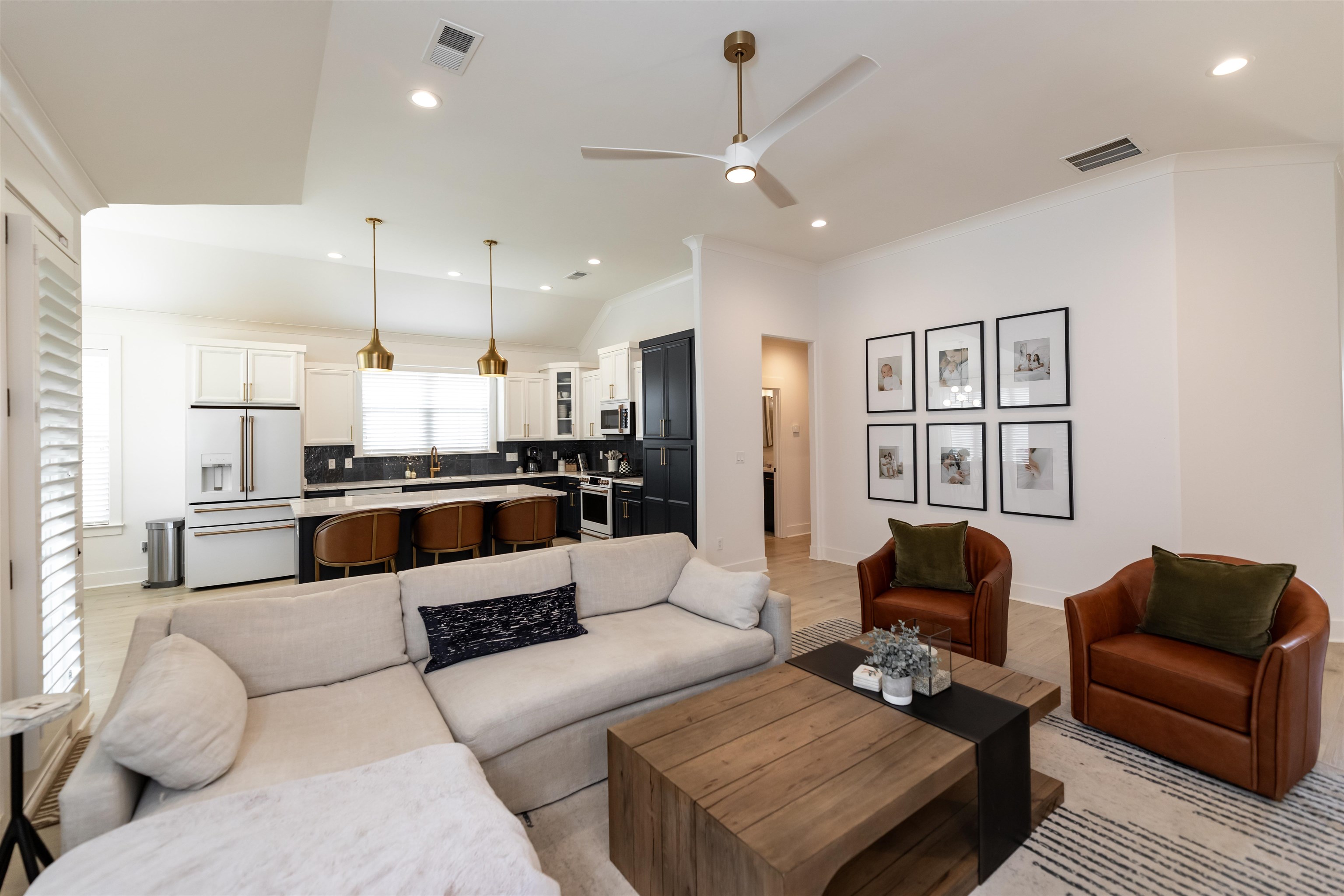Living room featuring ceiling fan and light hardwood / wood-style floors