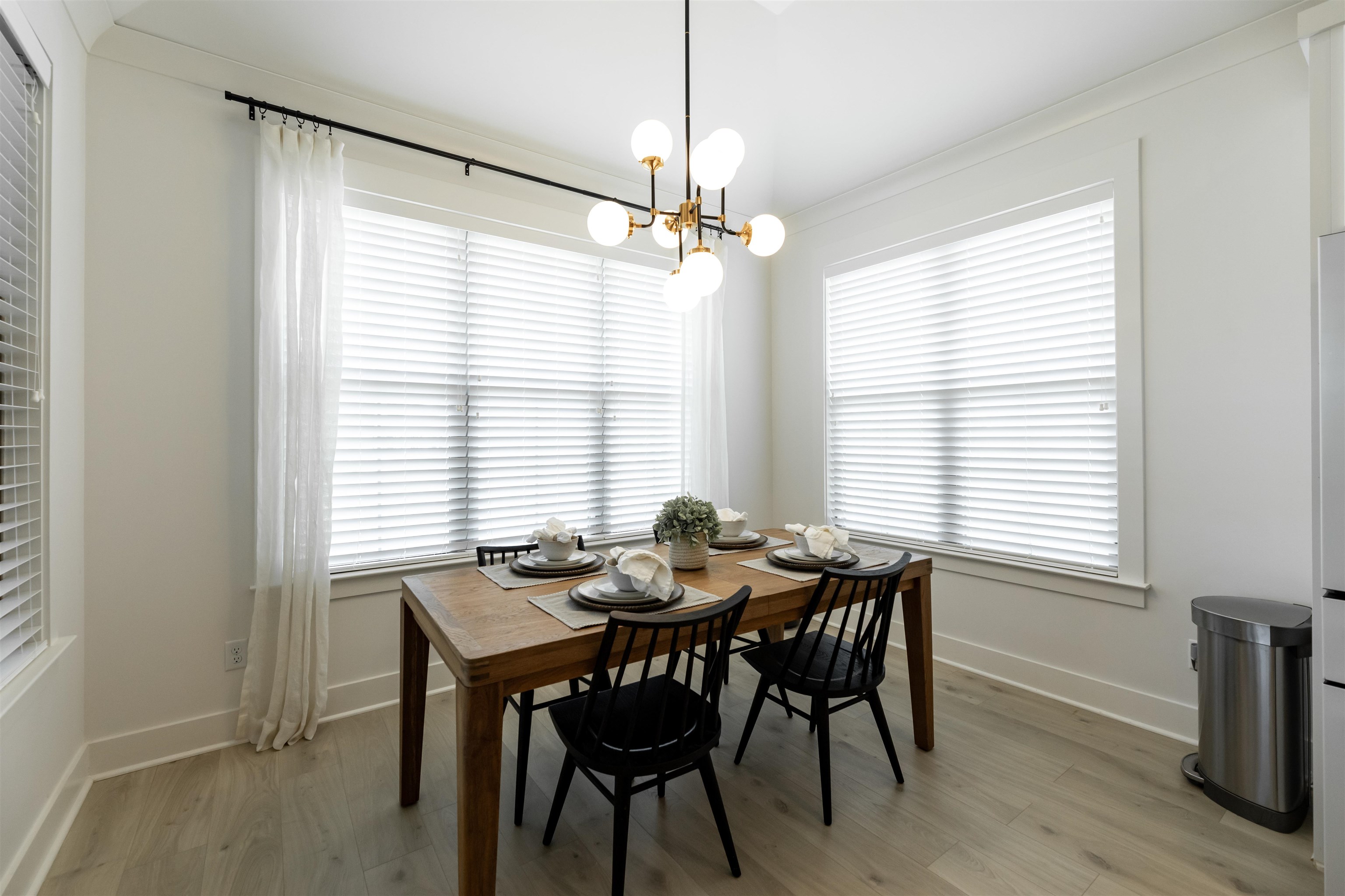 Dining area featuring ornamental molding, light hardwood / wood-style floors, and a chandelier