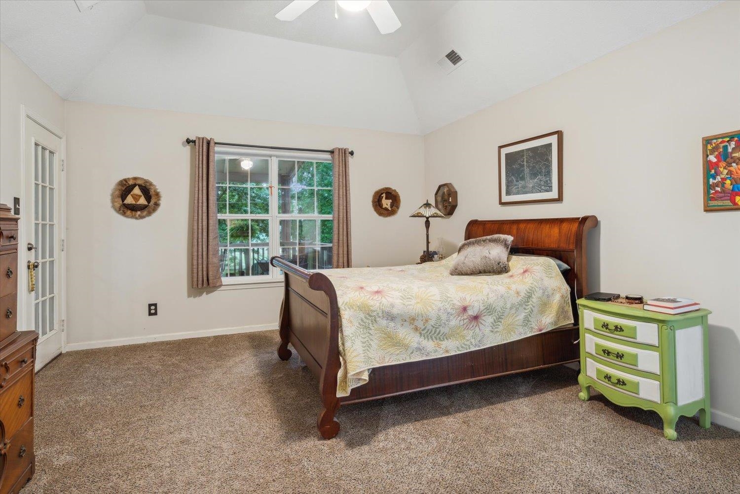 Bedroom featuring lofted ceiling, carpet floors, and ceiling fan