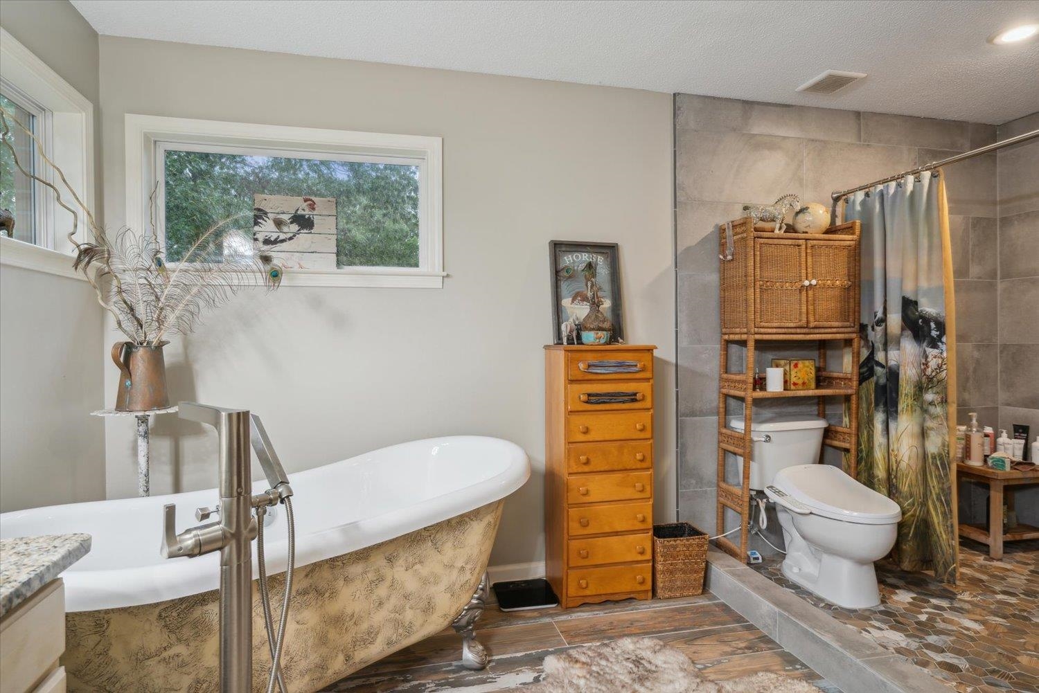 Bathroom featuring tile floors, a bathtub, toilet, and vanity