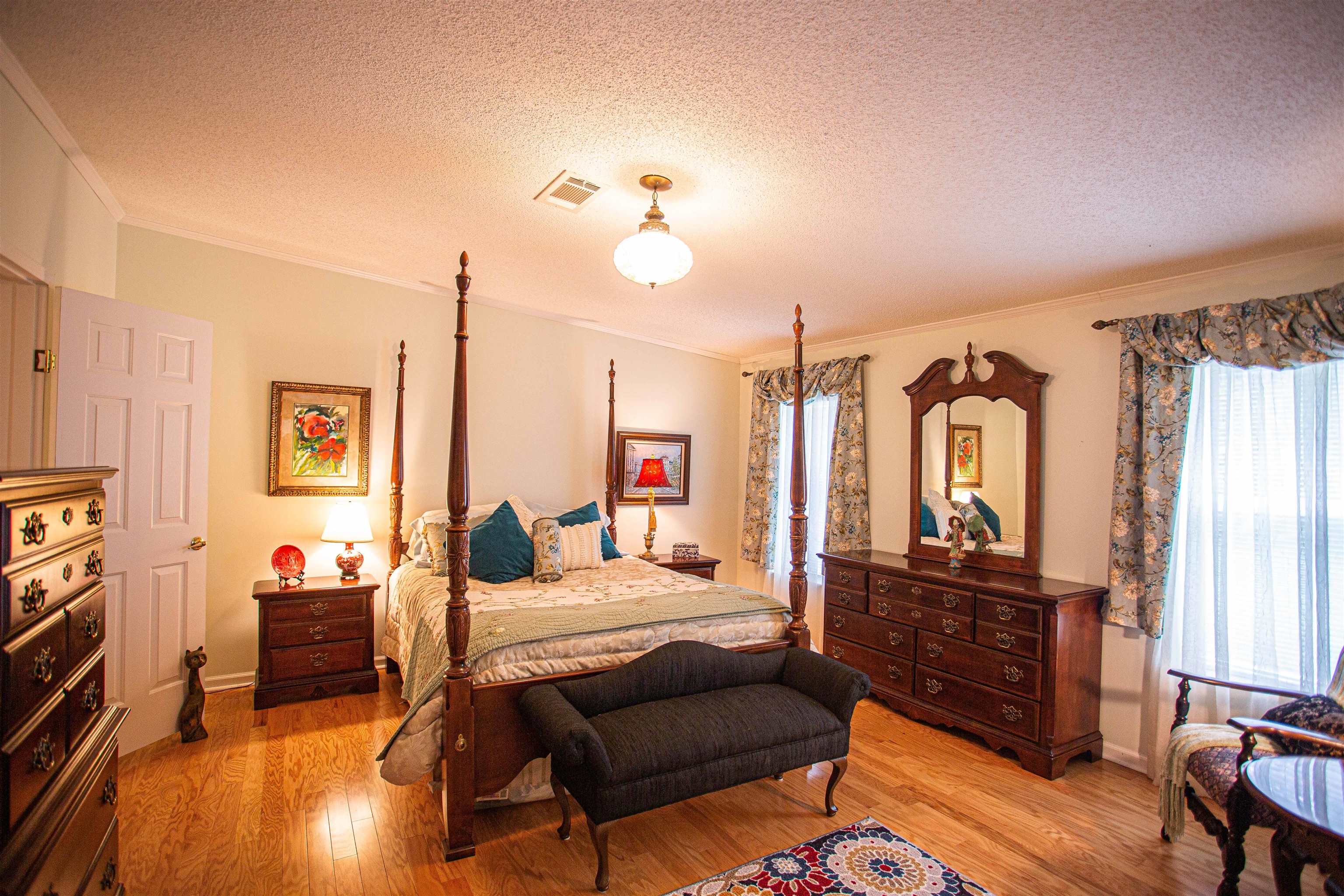 Bedroom with a textured ceiling and engineered hardwood flooring