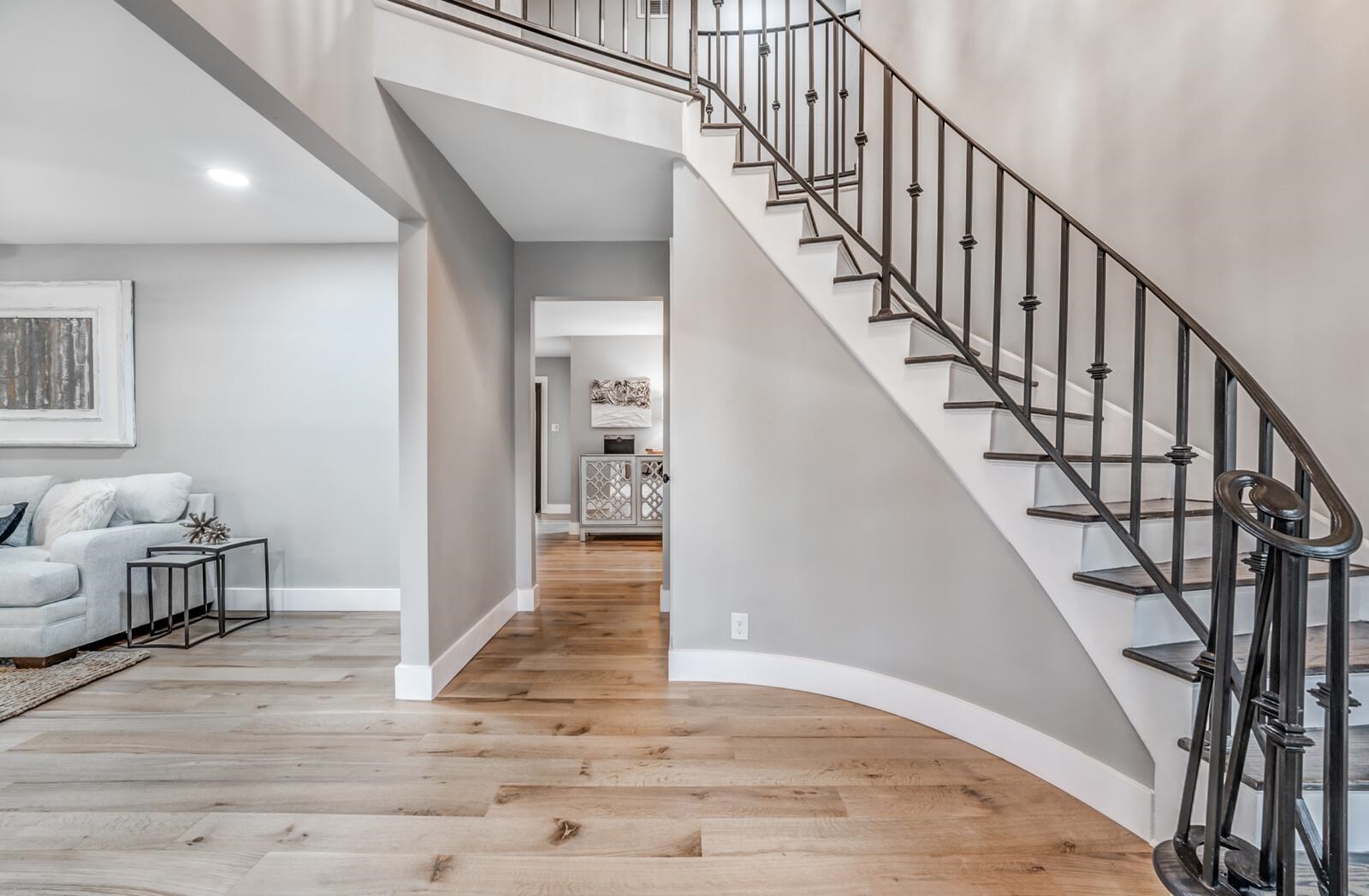 Entrance foyer with light hardwood / wood-style flooring and a high ceiling