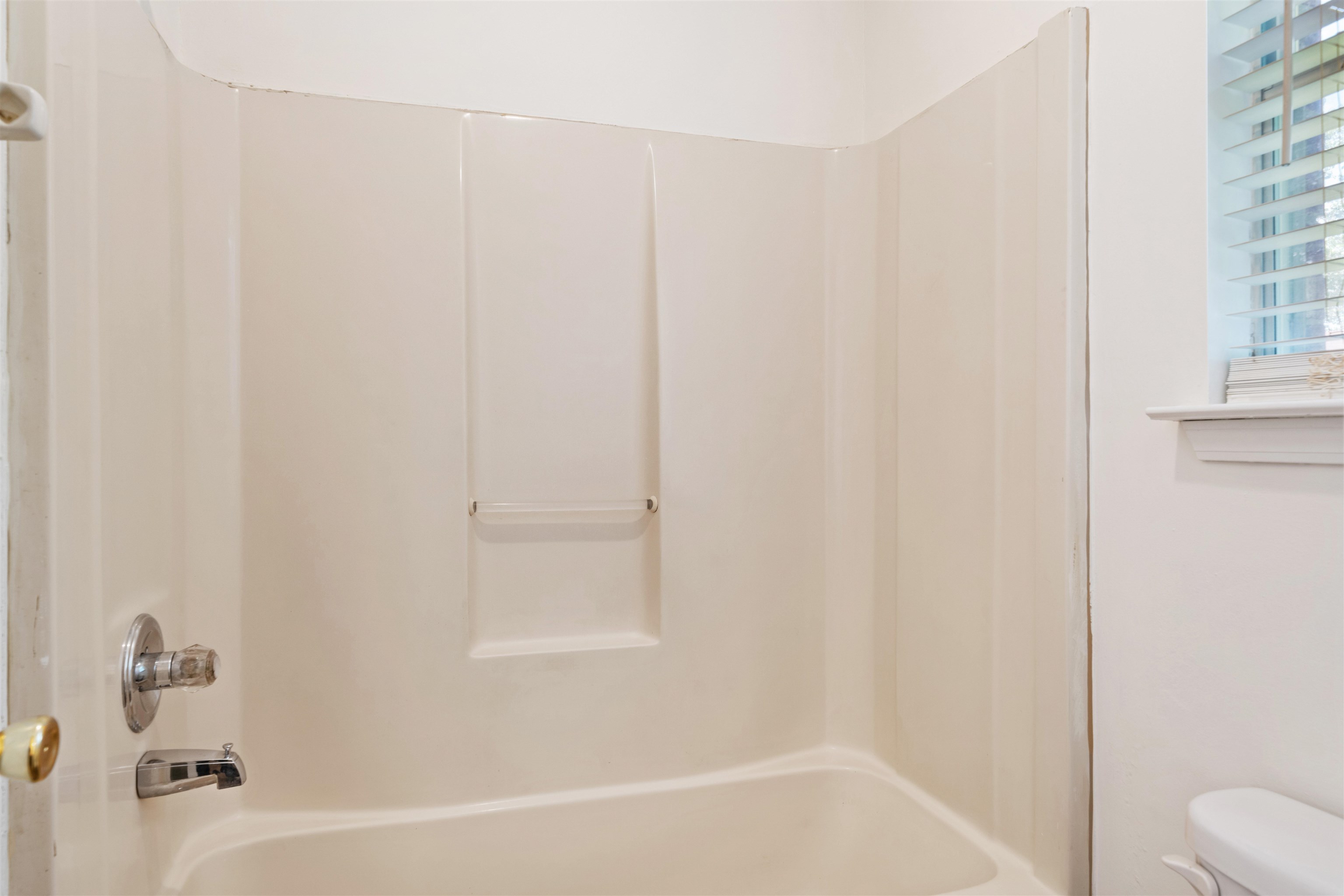 Bathroom with toilet and tub / shower combination, man made marble sink