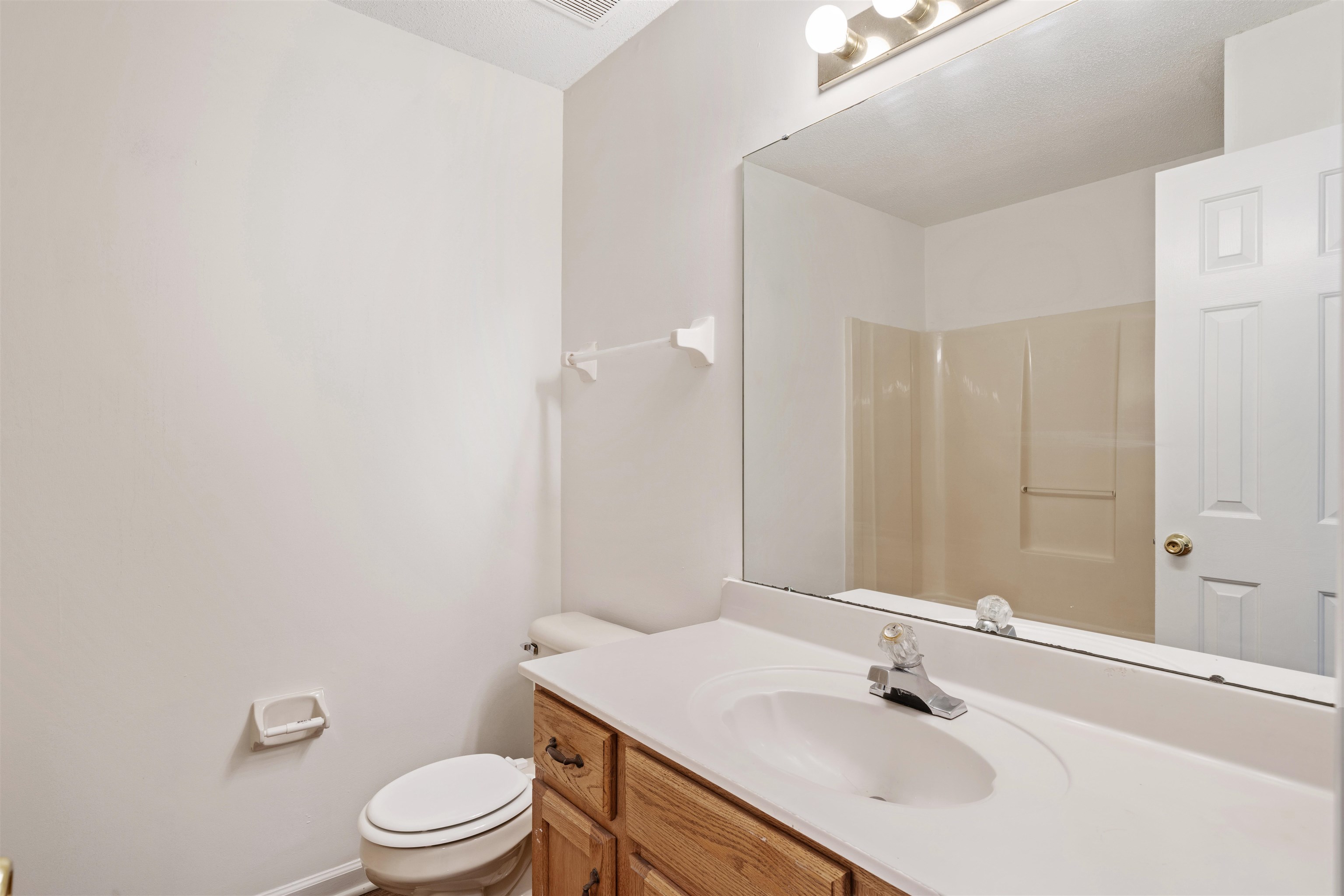 Bathroom 2 with vanity, toilet and wood type flooring