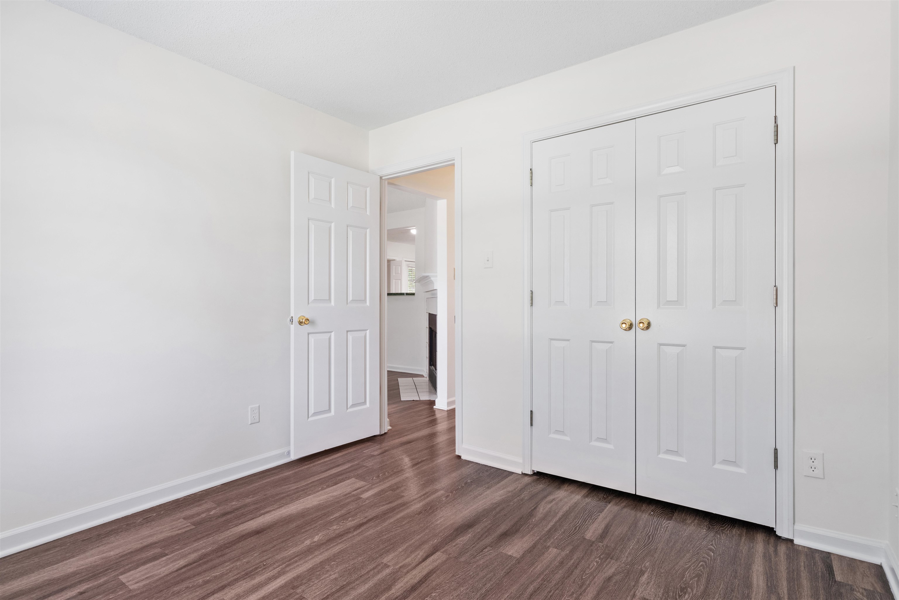 Bedroom 3 featuring dark hardwood / wood-style flooring and a closet