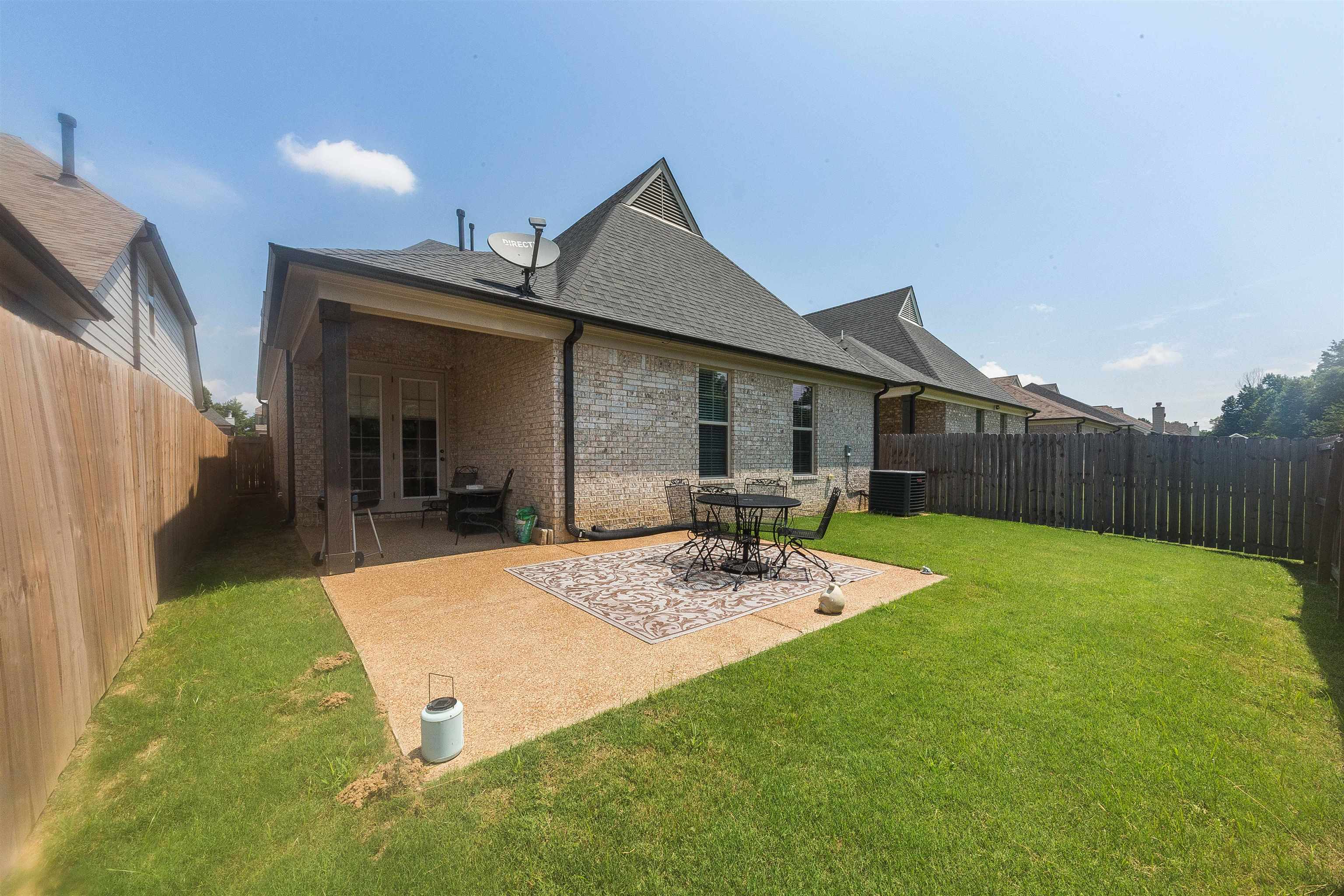 Back of house featuring a patio, a lawn, and cooling unit