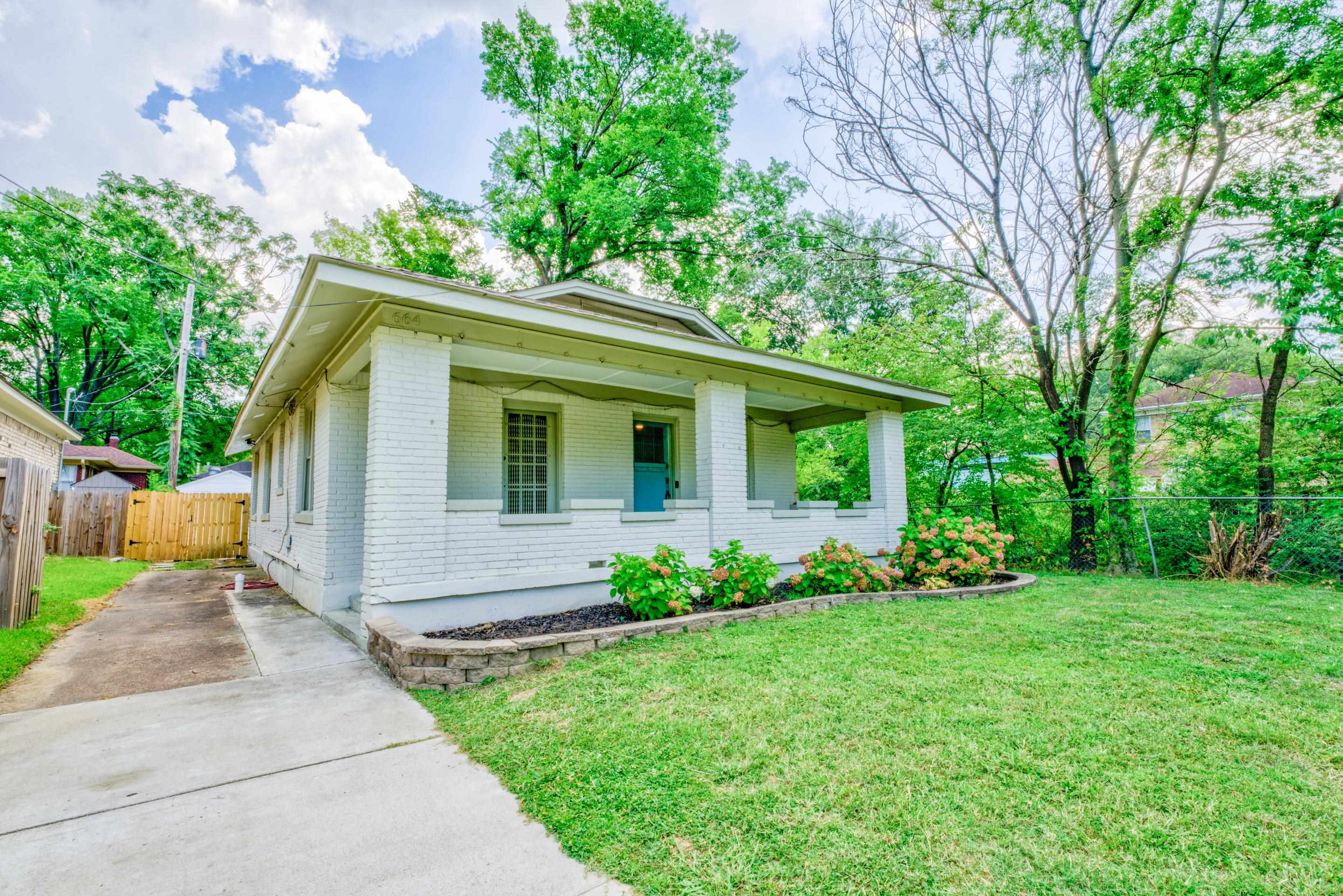 Bungalow with a porch and a front yard