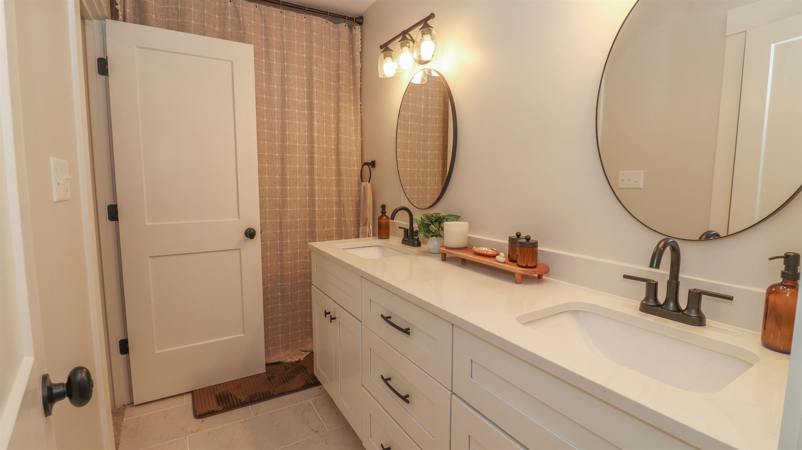 Bathroom with double vanity and tile patterned floors