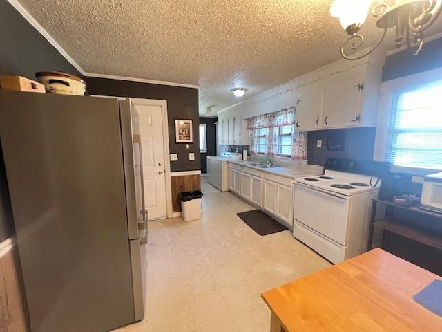 Kitchen featuring a notable chandelier, white cabinets, fridge, white electric stove, and light tile patterned floors