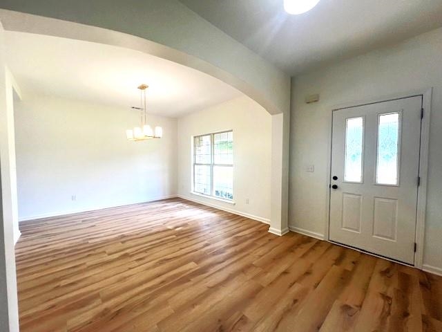 Entryway featuring hardwood / wood-style flooring and a chandelier