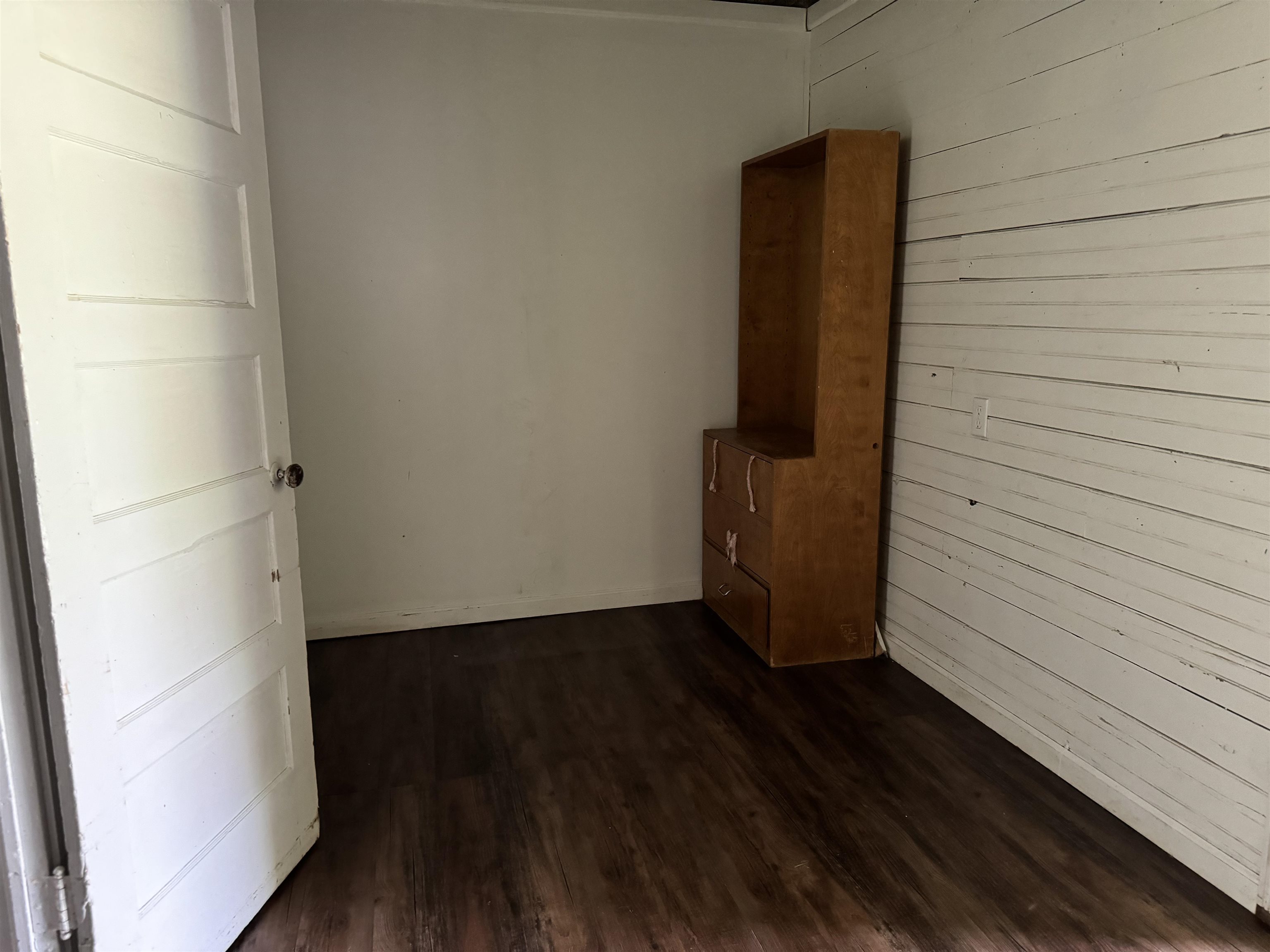 Empty room with dark hardwood / wood-style floors