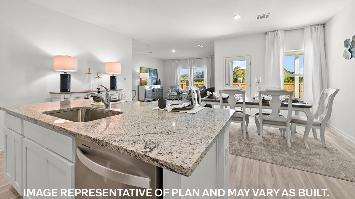 Kitchen featuring a center island with sink, sink, light hardwood / wood-style floors, stainless steel dishwasher, and white cabinetry