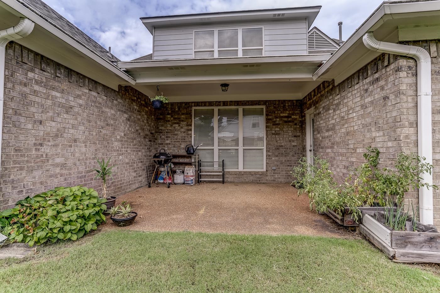 View of exterior entry featuring a yard