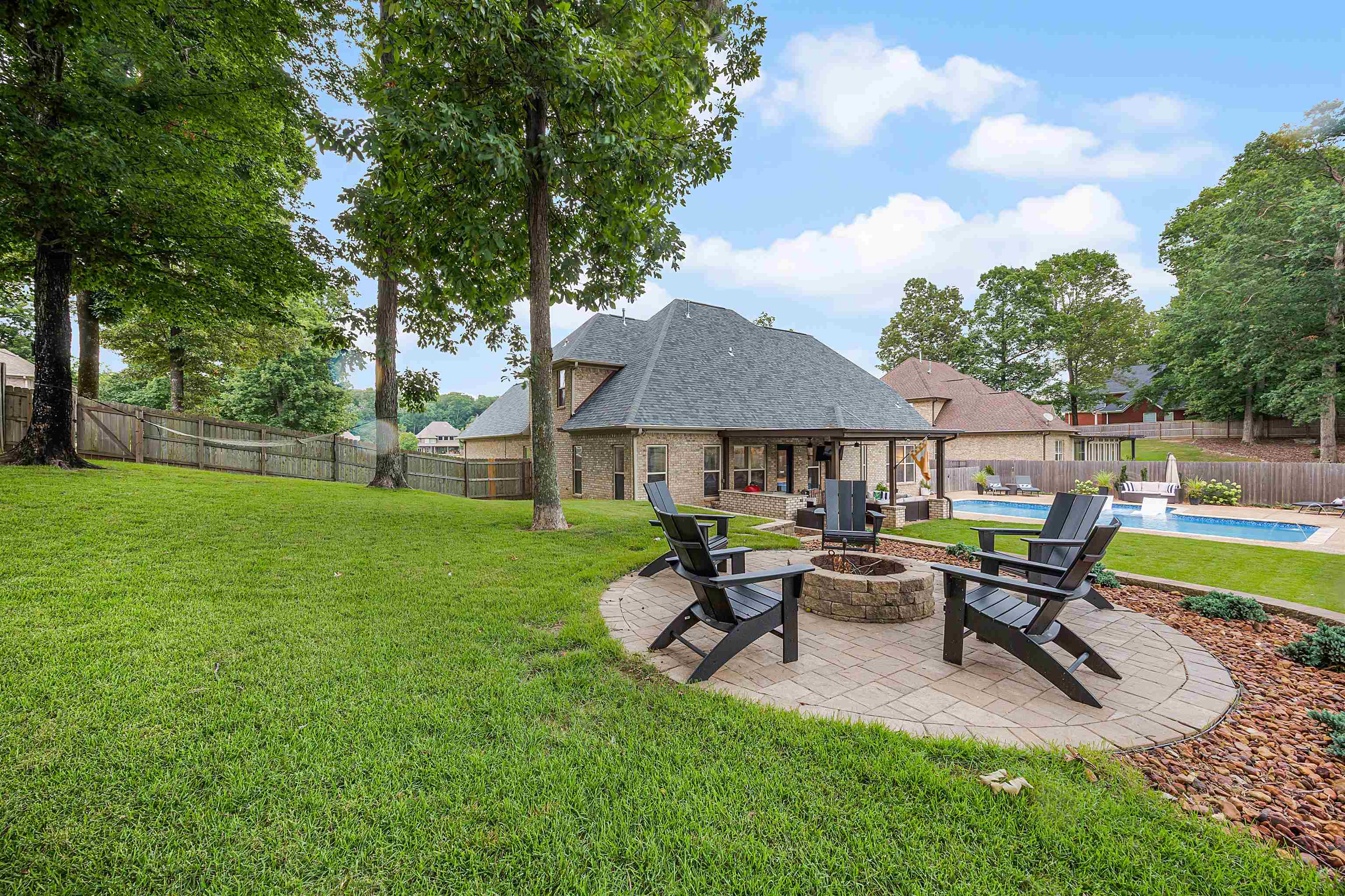 View of yard featuring an outdoor fire pit, a patio area, and a fenced in pool