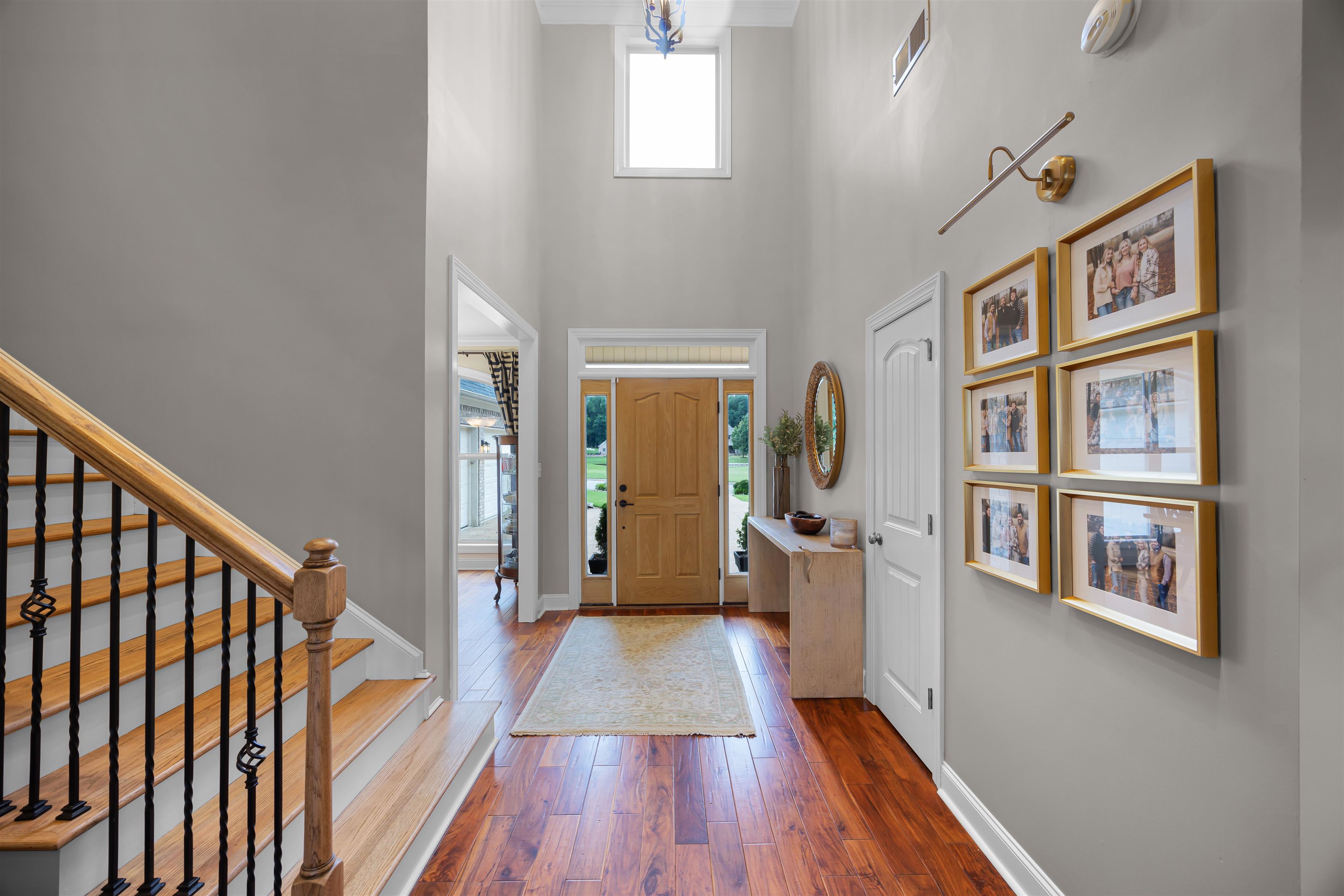 Foyer entrance with hardwood / wood-style flooring and a towering ceiling