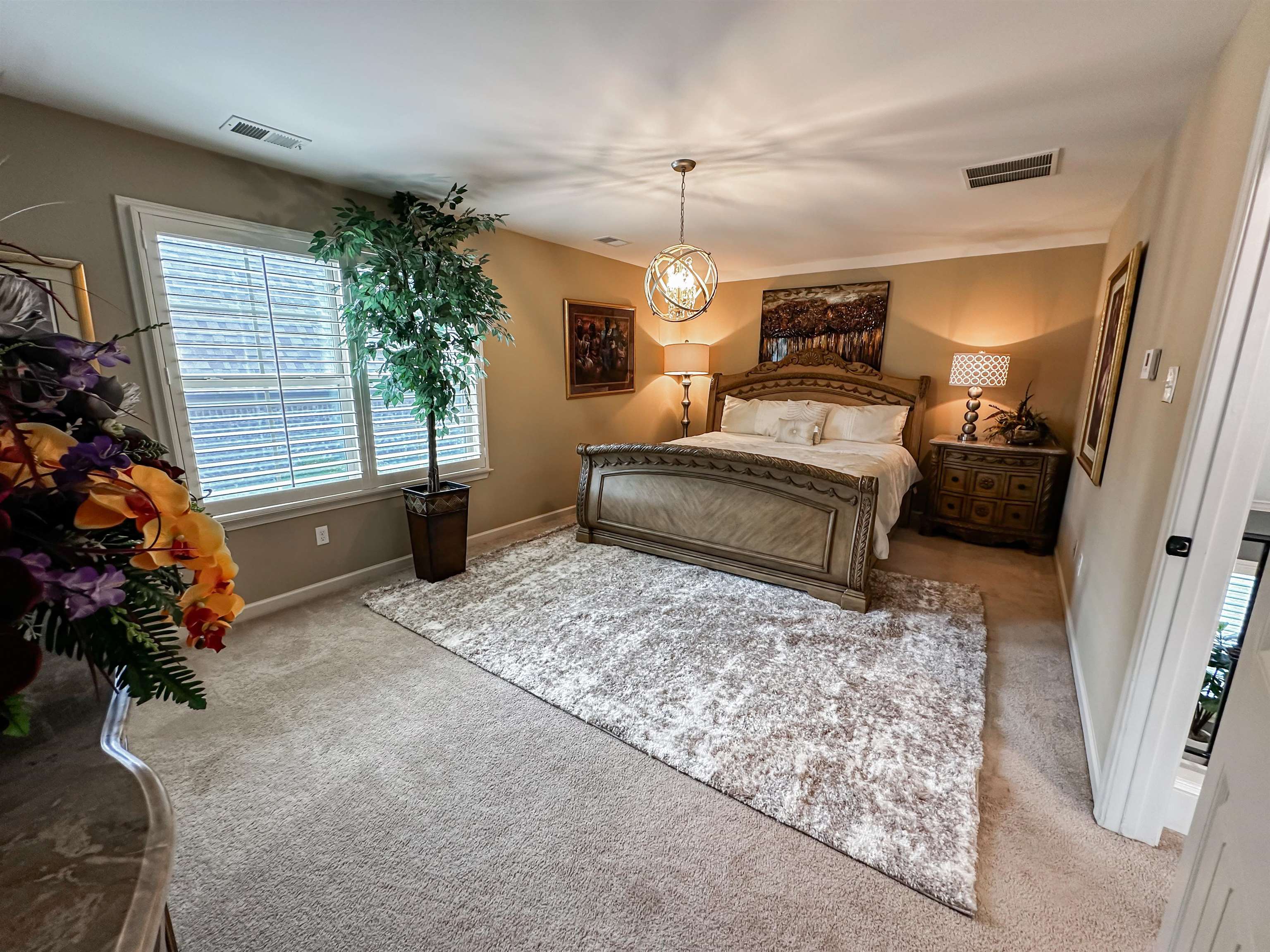 Bonus room that could be used as a 5th Bedroom with carpet floors and an inviting chandelier