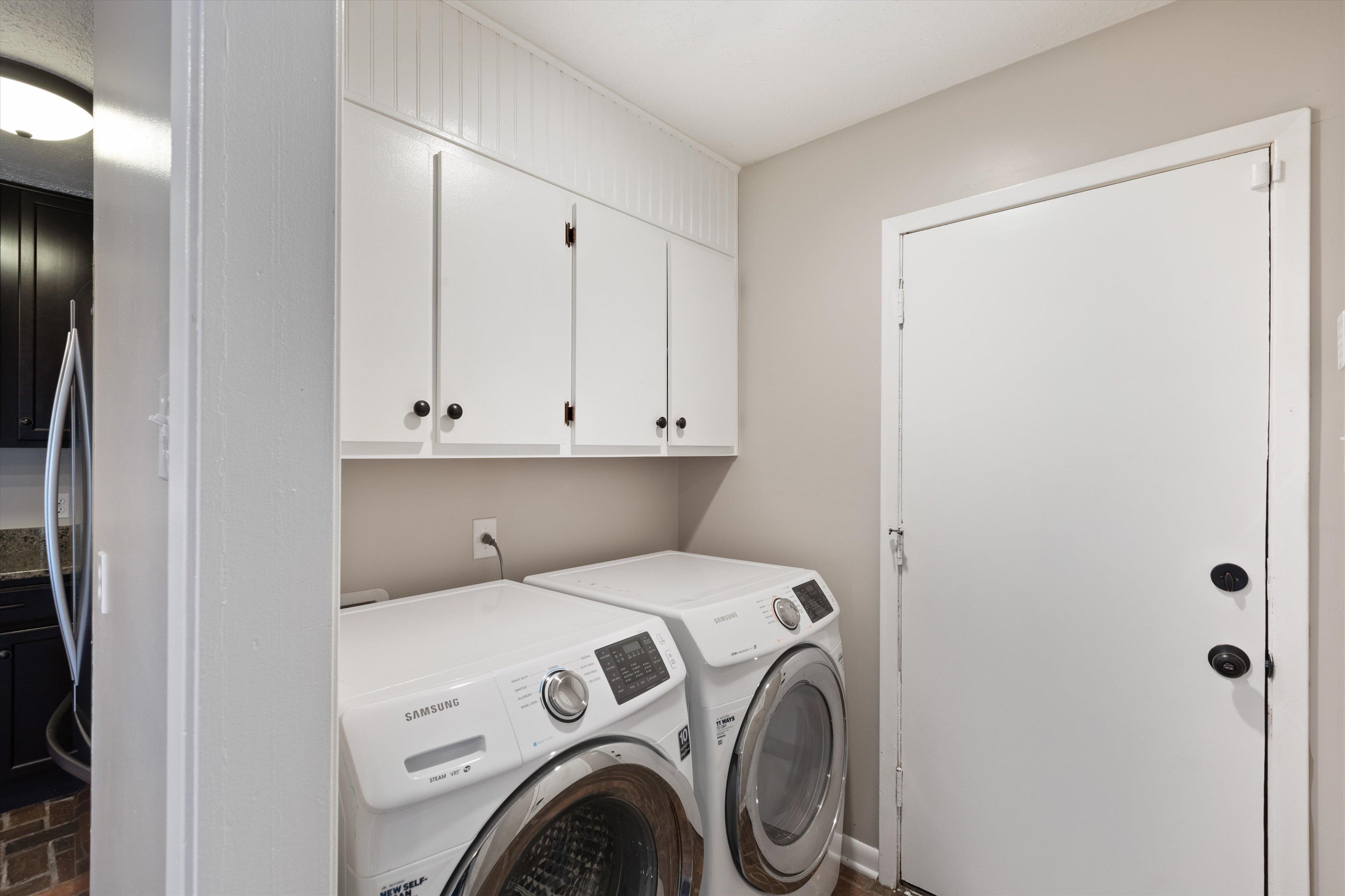 Clothes washing area with washing machine and clothes dryer and cabinets