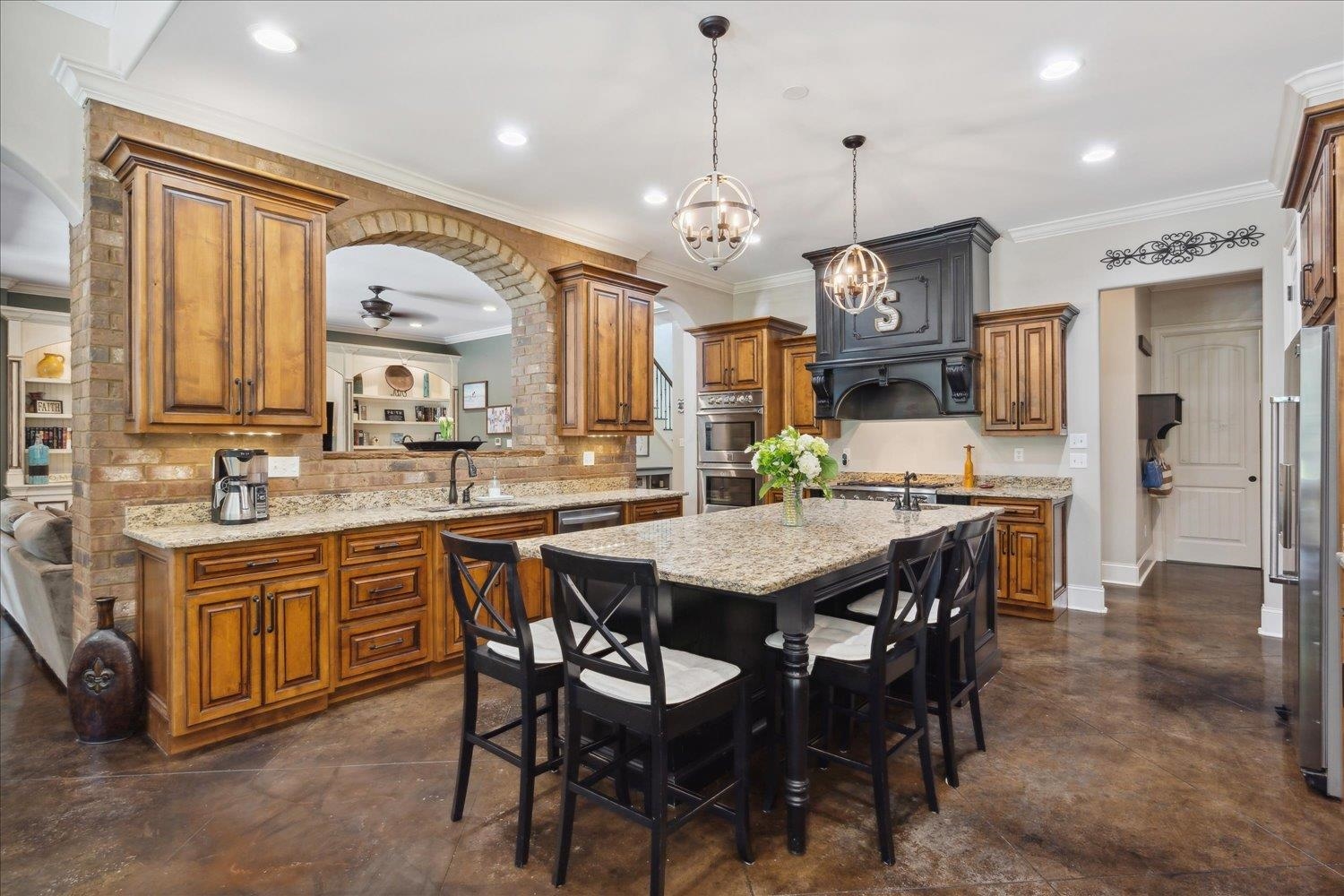 You will love this large, gourmet kitchen featuring handcrafted custom cabinetry. Huge island with granite, vegetable sink & ice maker.  Other amenities include Kenmore Pro 6 burner gas cooktop& double ovens & Kenmore Elite stainless steel dishwasher.